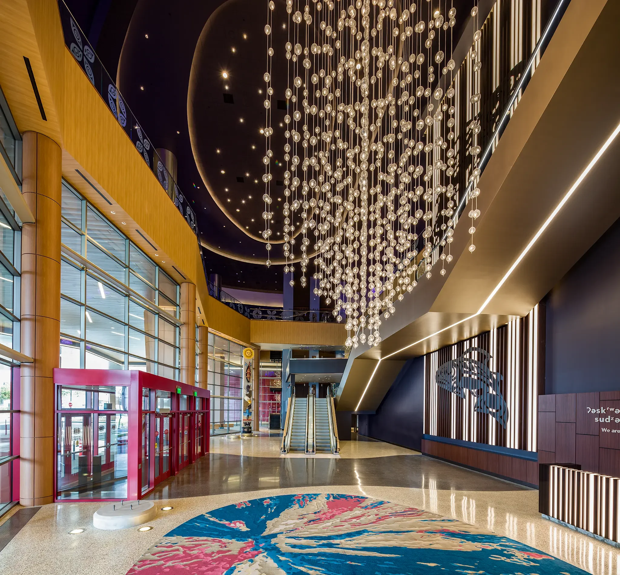 Daytime Valet Entry featuring stunning lighting feature and architectural design elements inside the Emerald Queen Casino project by Cuningham Architects.