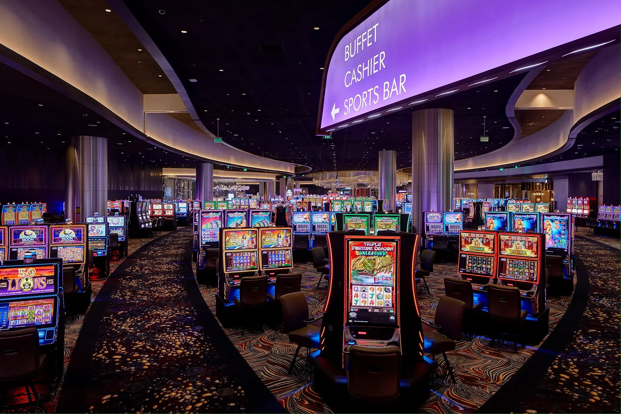 Gaming floor interior architecture highlighting clear wayfinding design and prominent backlit signage inside the Emerald Queen Casino project by Cuningham Architects.