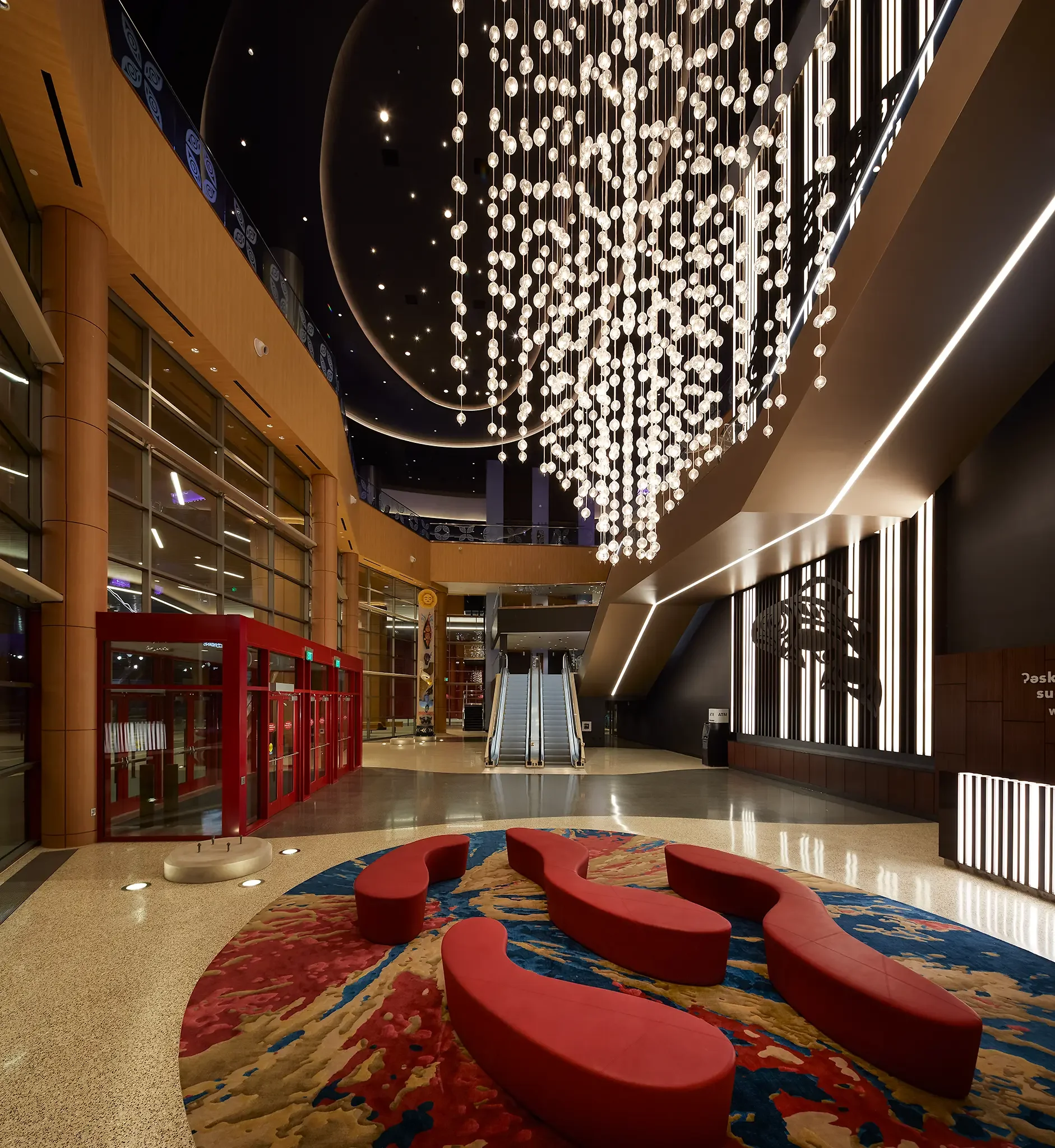 Grand Valet Entry featuring stunning Native artwork display and architectural design inside the Emerald Queen Casino project by Cuningham Architects.
