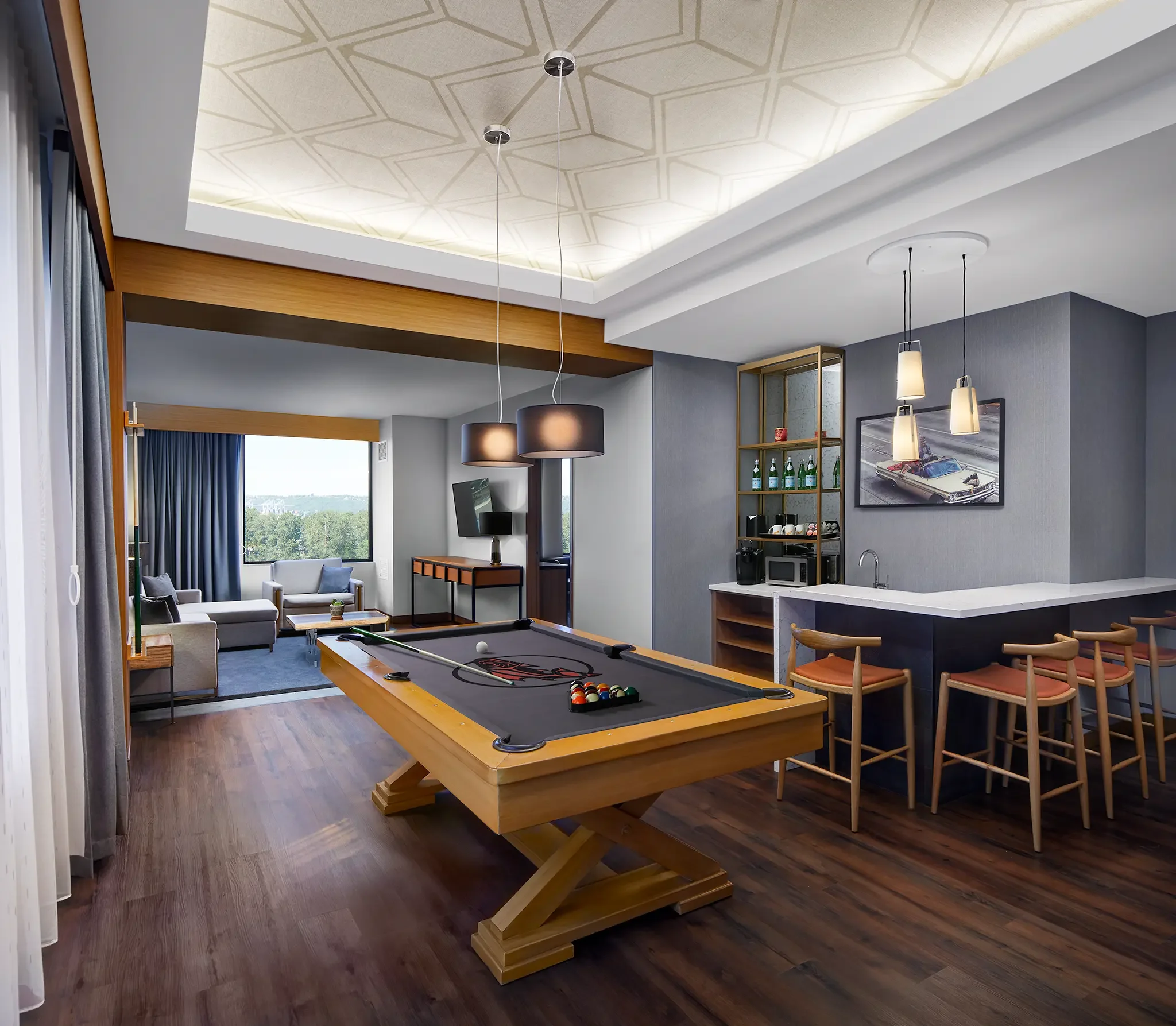 Suite with pool table inside guest room interior design and custom FF&E by Cuningham Architects at the Emerald Queen Casino Hotel in Tacoma, Washington.