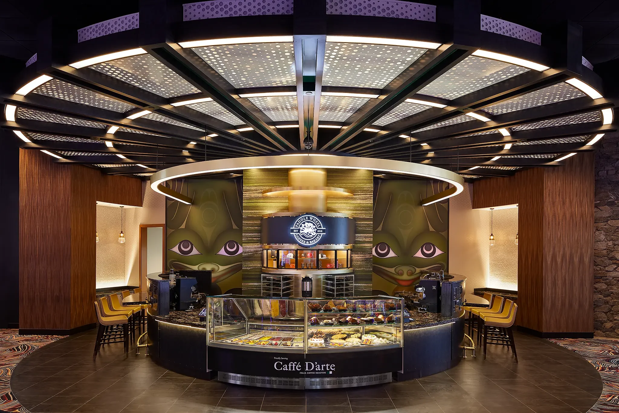 Interior view of the Paddle Wheel Coffee & Bakery, Tacoma, WA, featuring retail display cases and cafe seating, designed by Cuningham Architects.