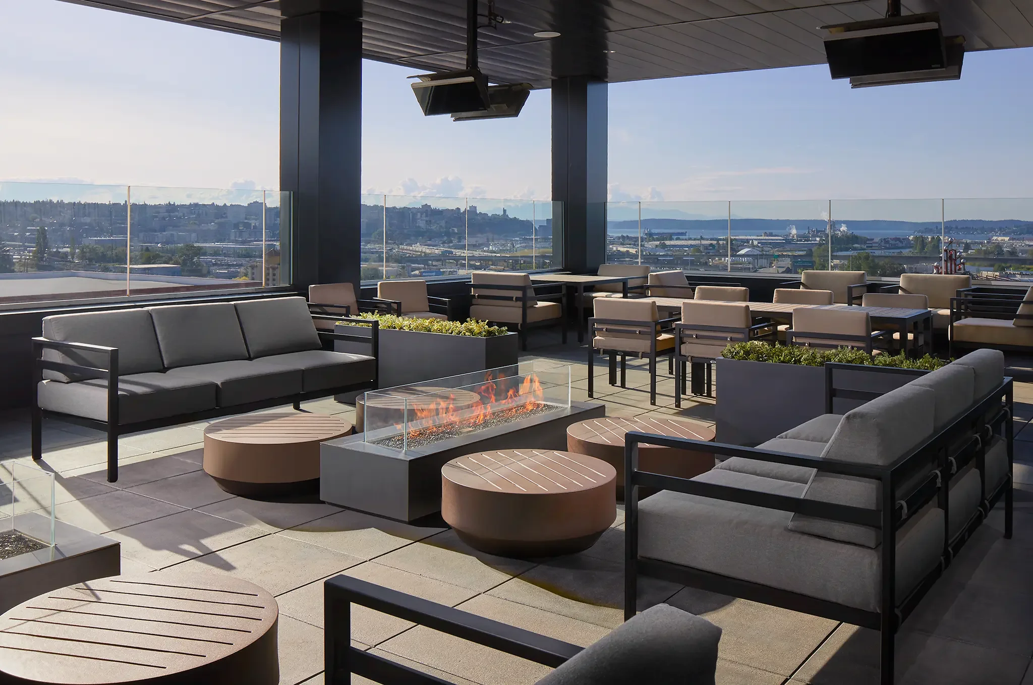 Architectural photo of the Slahal outdoor bar and patio seating area with views of Tacoma and Puget Sound, Tacoma, WA, designed by Cuningham Architects.