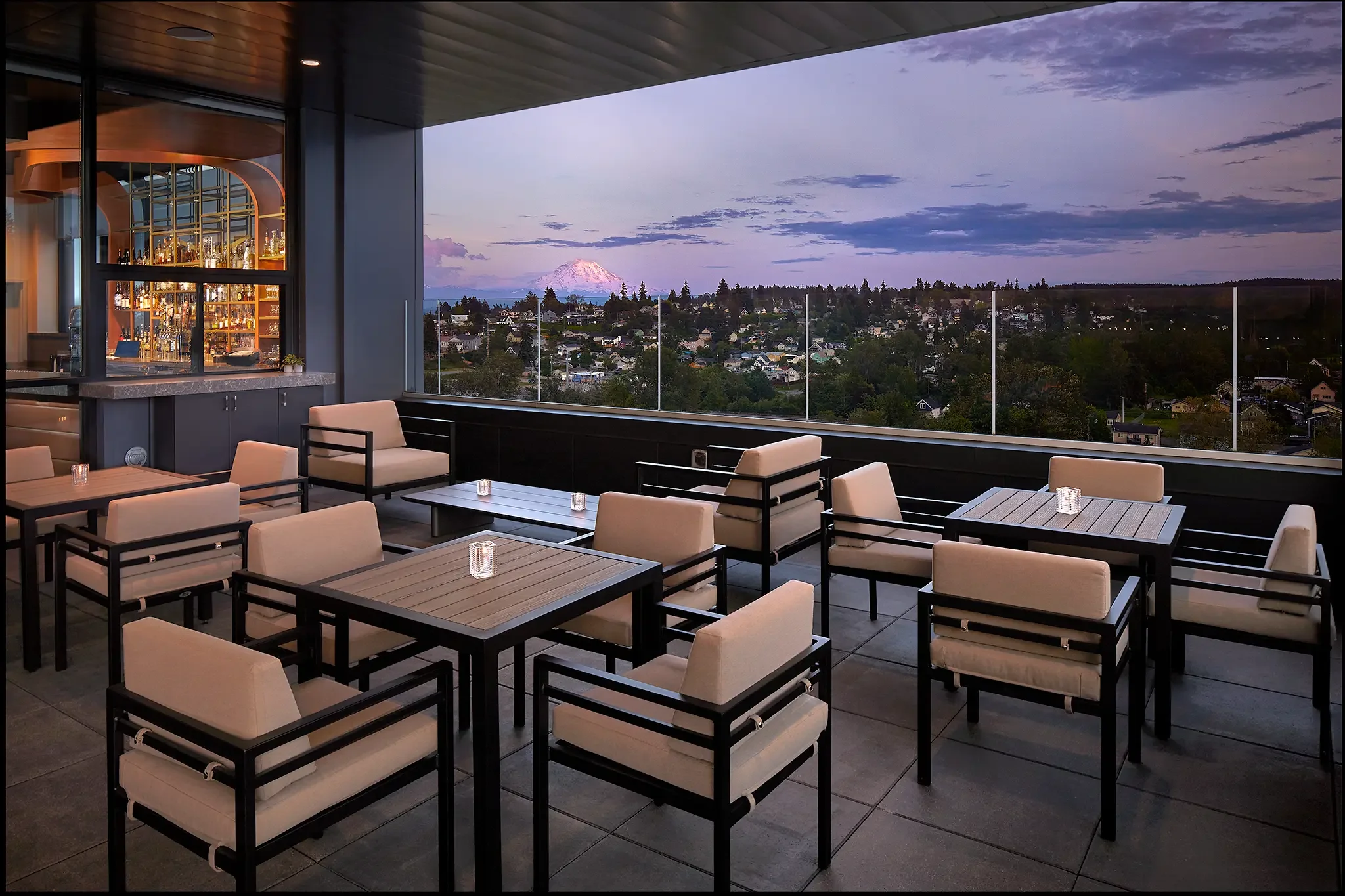 Dusk photo of the outdoor bar and patio seating with Mt. Rainier views, Slahal Steakhouse, Tacoma, WA, designed by Cuningham Architects.