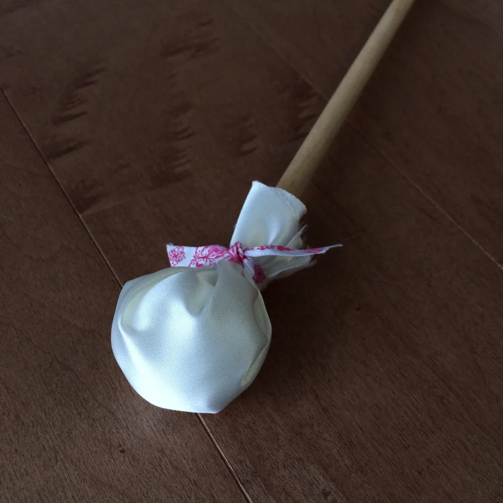 a dowel stick, cotton balls, silk and a ribbon