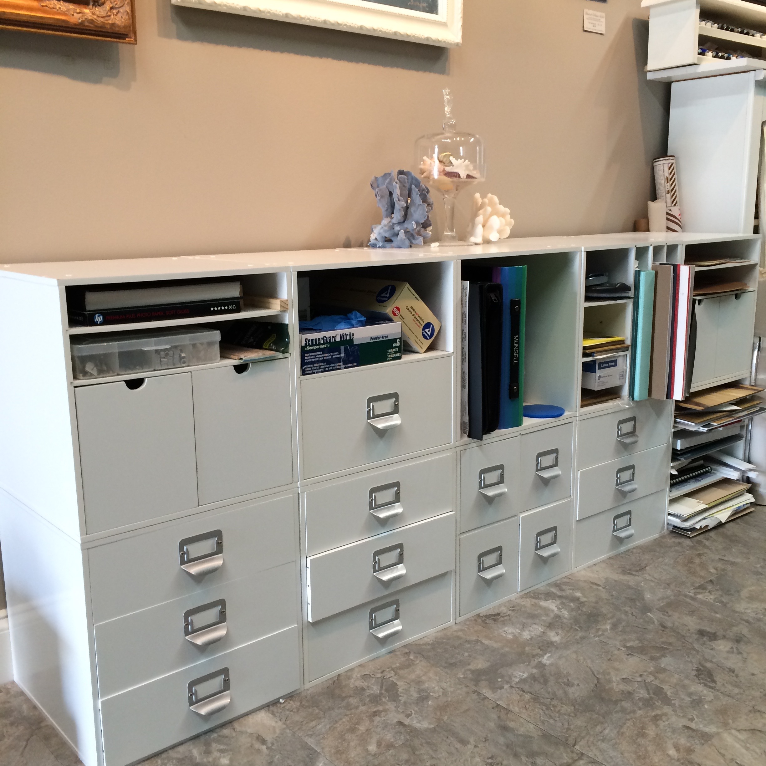 a wall of organizer containers for art supplies