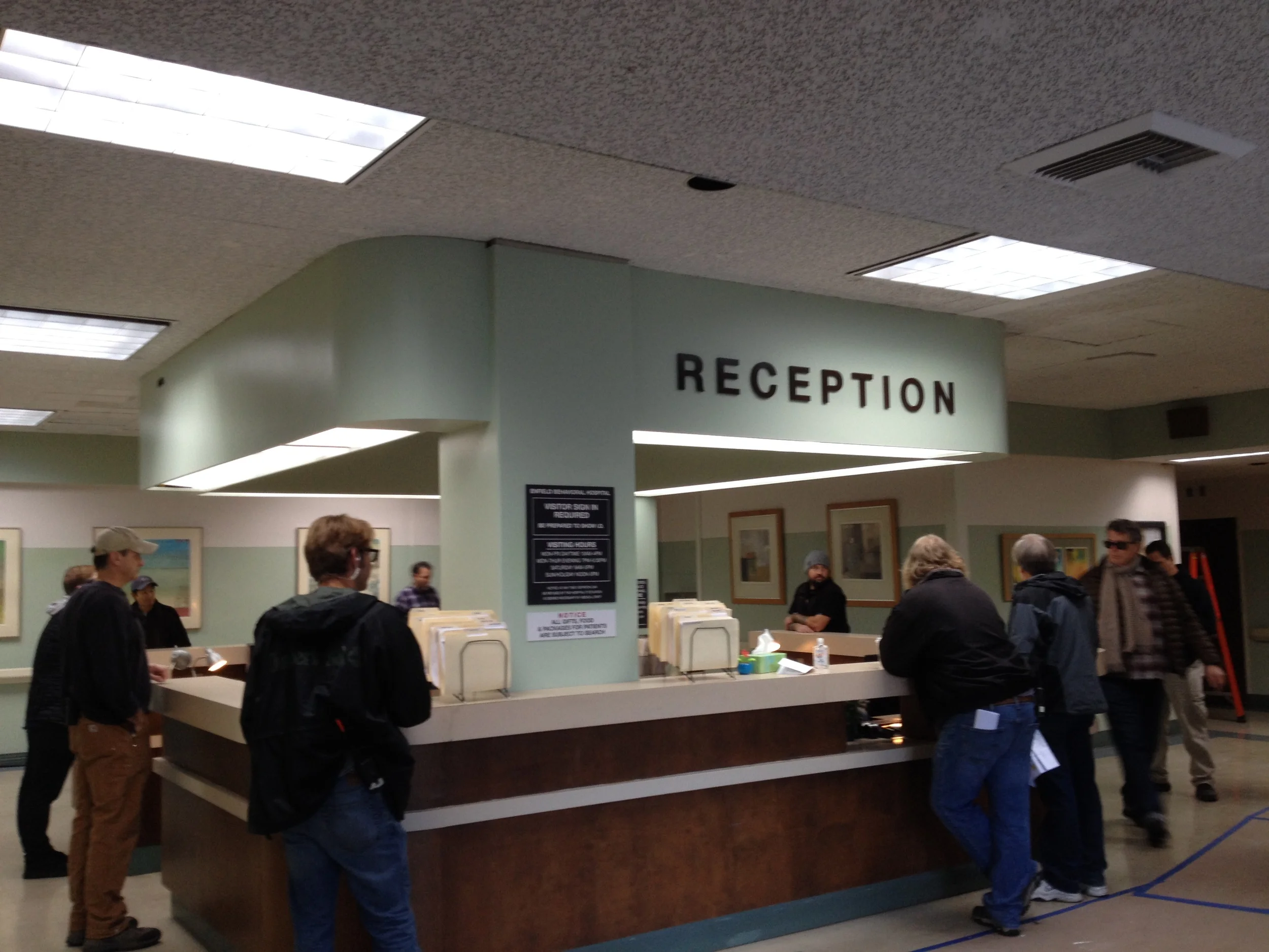 INT. MENTAL HOSPITAL - RECEPTION AREA