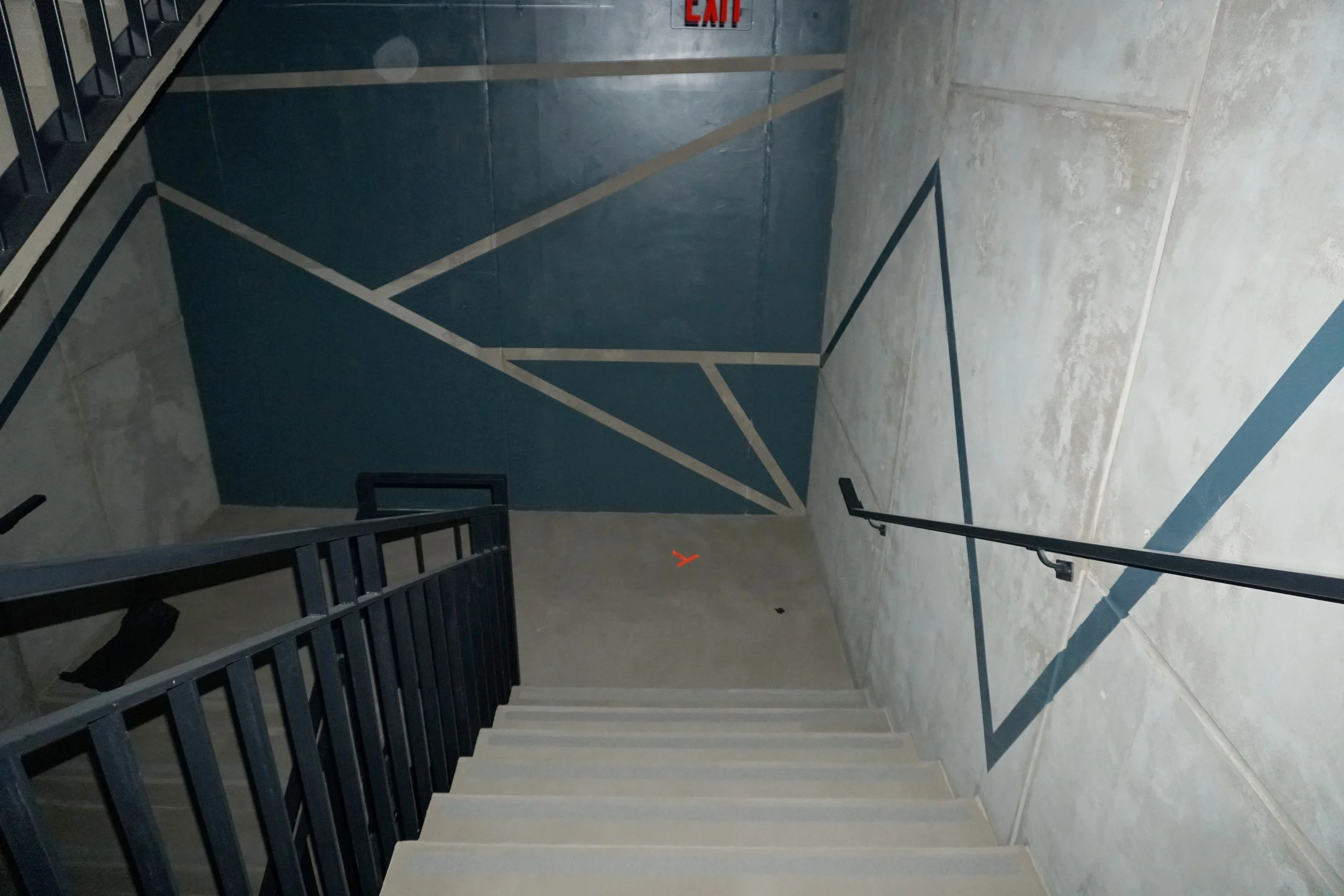INT. ETHAN CHOI'S LOFT STAIRWELL
