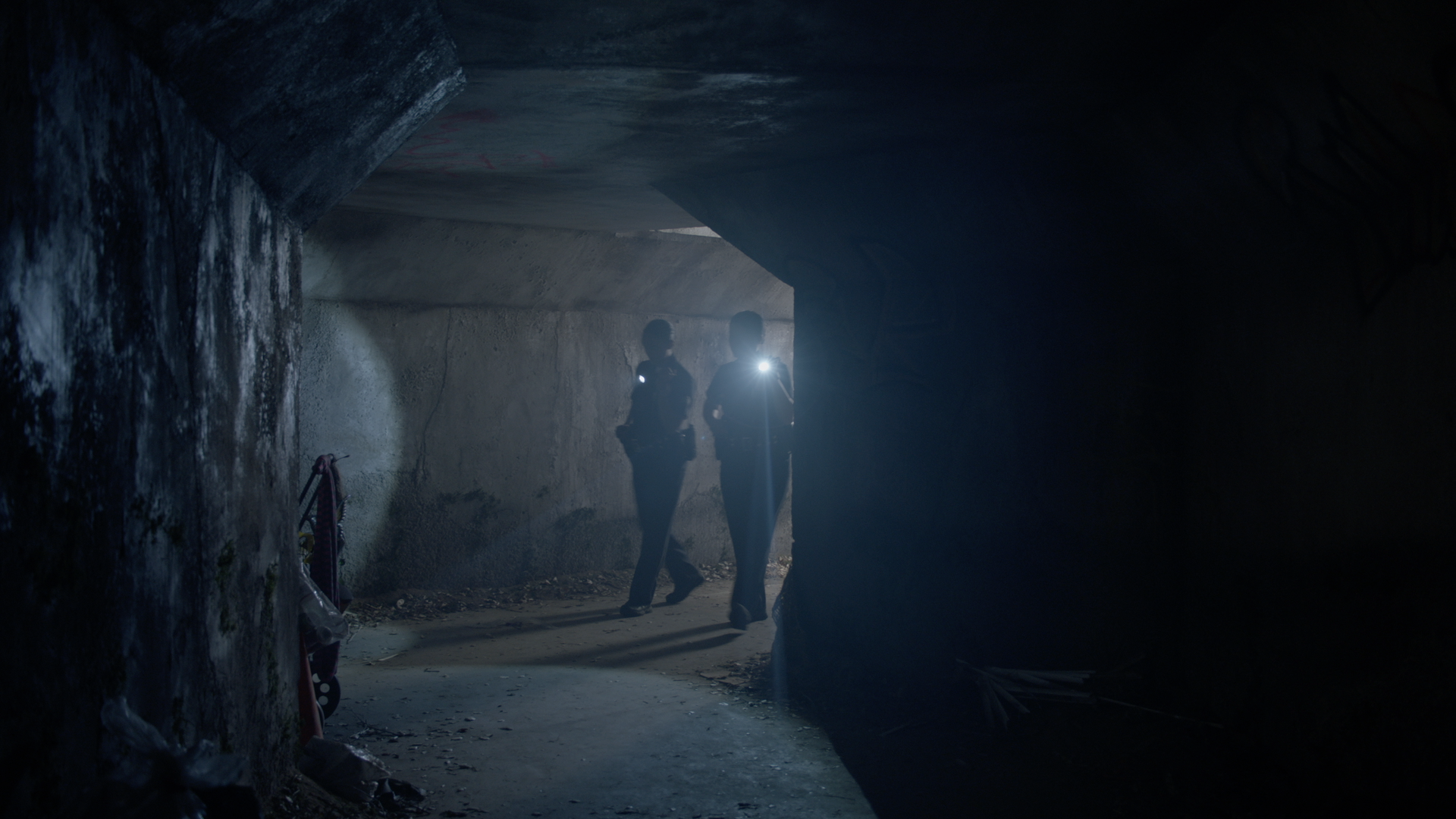 INT. STORM DRAIN/HOMELESS ENCAMPMENT - STAGE BUILD