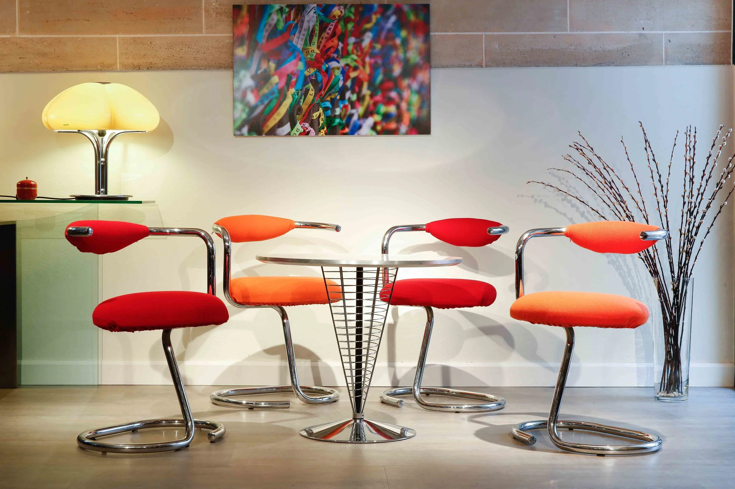 Four chairs with a tubular chromed metal structure by Giotto Stoppino