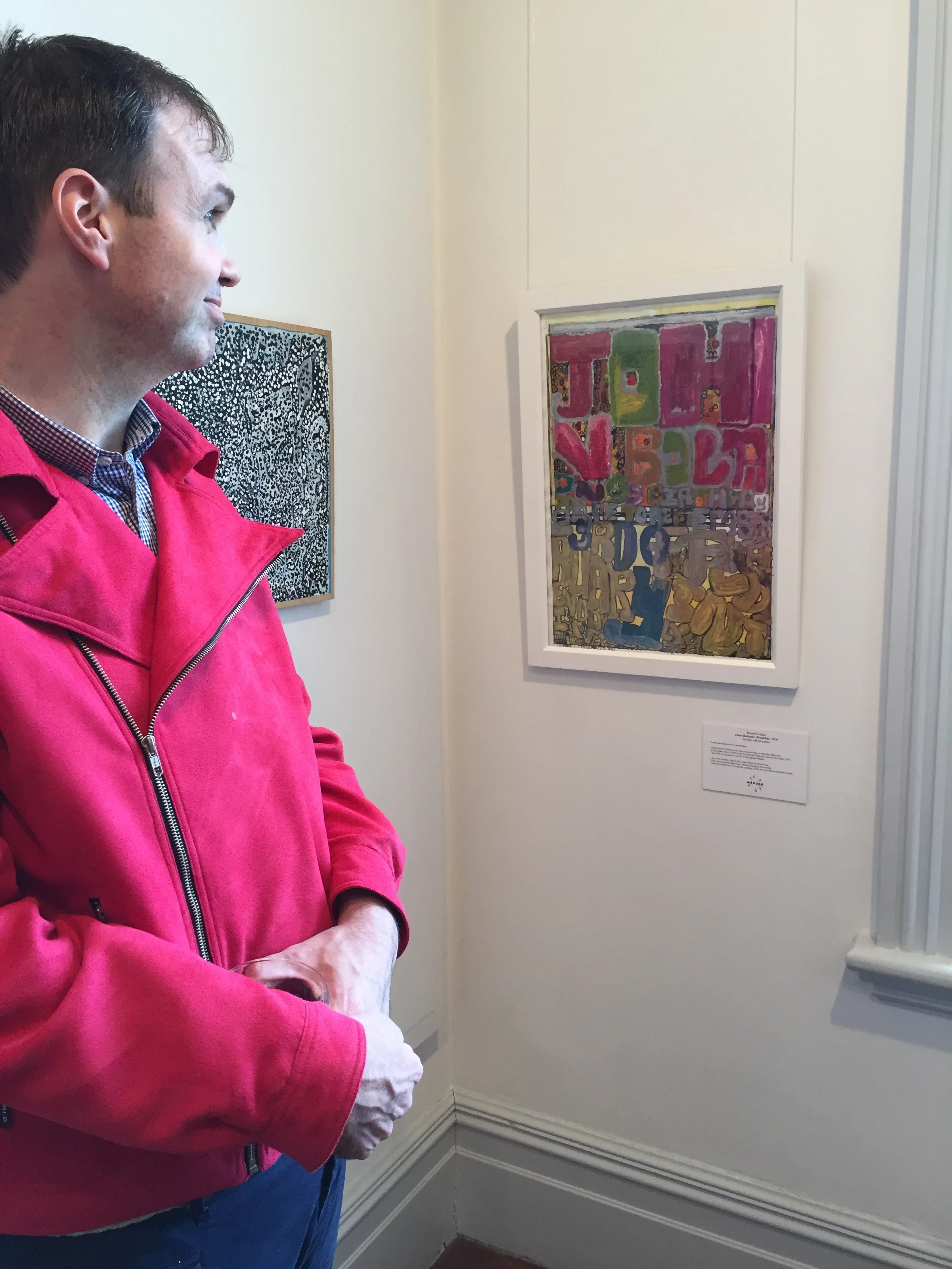 Russell Julian with his artwork at the opening of "Good Shapes"