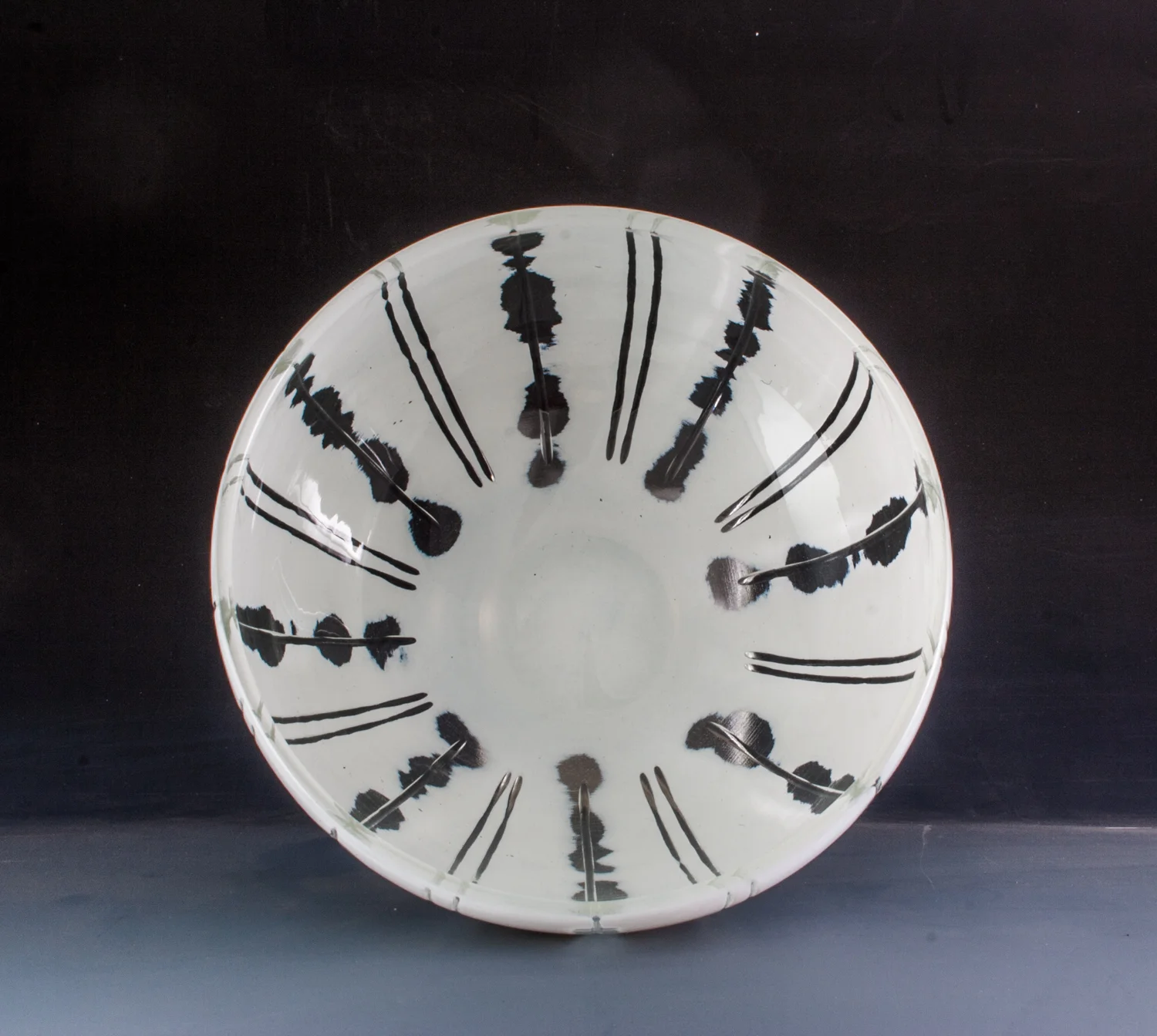 carved white bowl with radial design