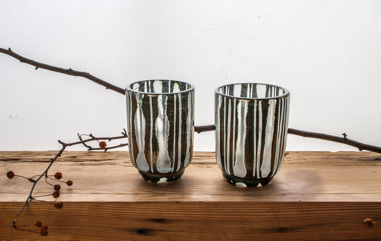 CARVED / this series uses a technique of rough carving blown pieces and them partially fire-polishing them. Forms include bowls, vases and yunomi ( Japanese tea cup ) here I'm exploring my life time obsessions with intuitive mark making, pattern traditions, windows, and trying to introduce more tactility to glass. SHOP CUPS