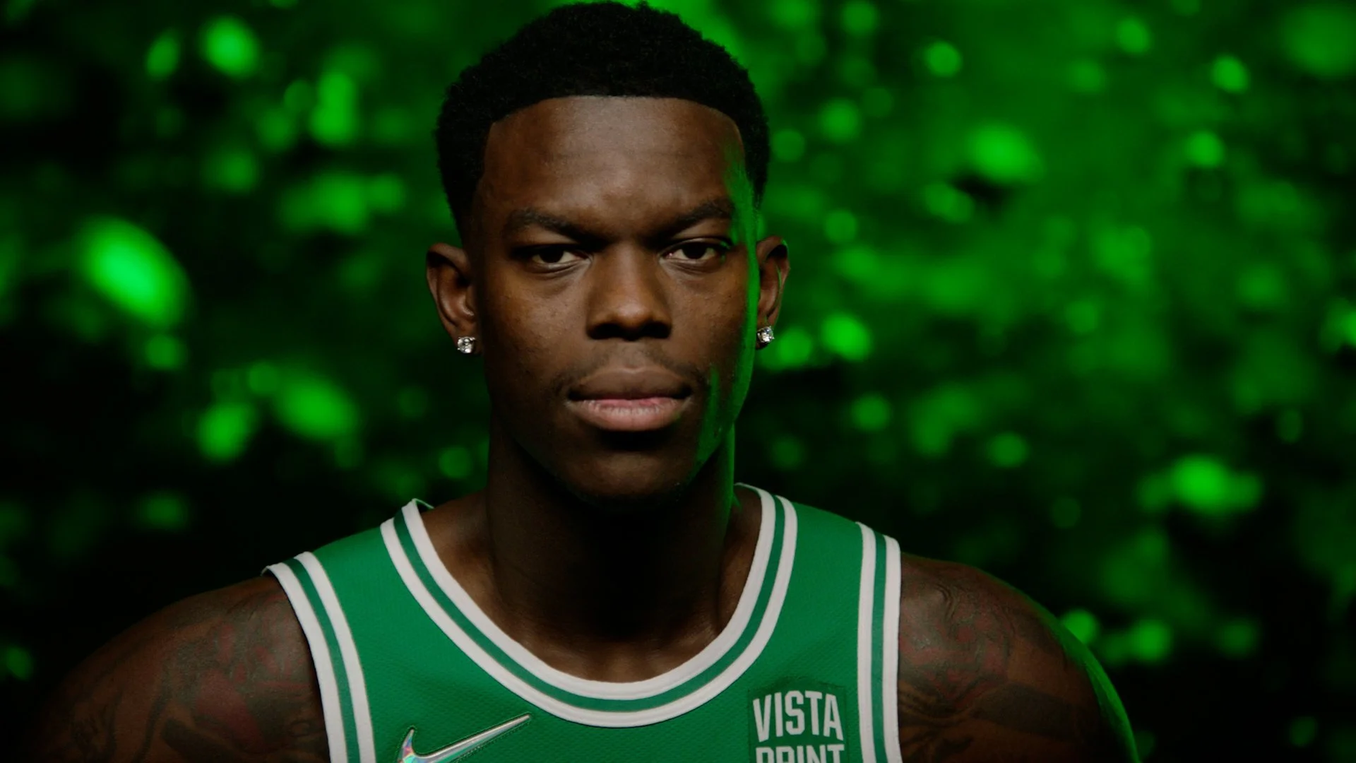 Basketball player in a green jersey with a serious expression, green dynamic background. Boston Celtics
