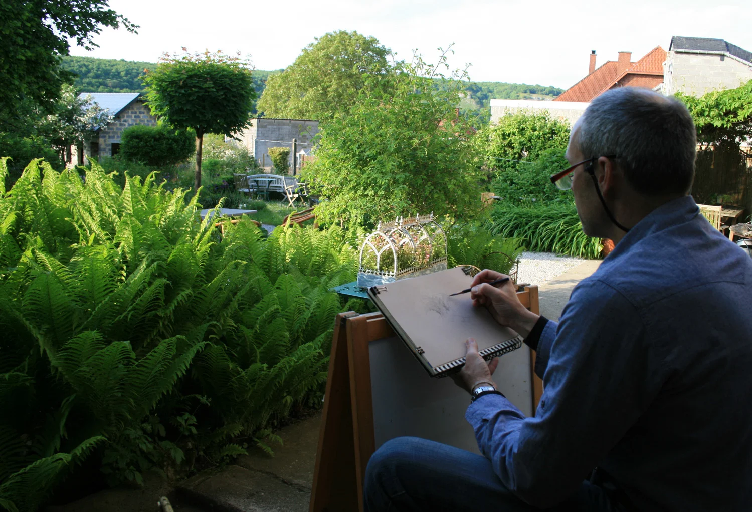 Photo of me sketching my relatives garden in Belgium.