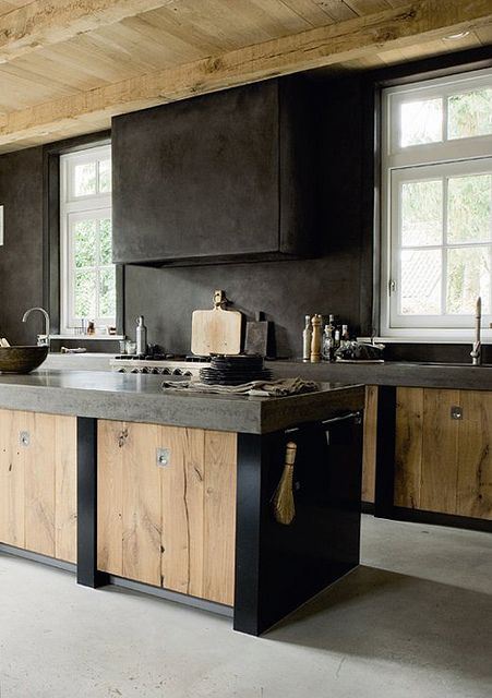 Black concrete makes a rich contrast to light wood cabinetry