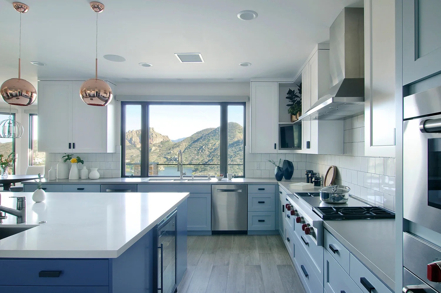 ROOM TO MANEUVER Expansive counter space, an over-sized sink, and a six-burner Wolf cooktop and double-oven means this family can go to work! (If they can stop looking out the window.)
