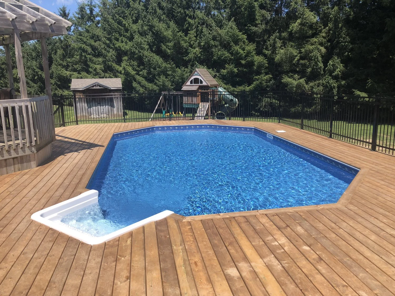 A Large Deck and Fencing Around an On-Ground Pool