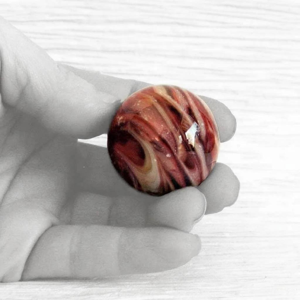 Glass Cremation Ash Infused Marble in Hand 2.jpg