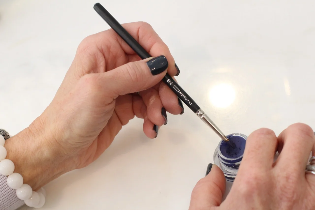 Line upper lid with a thin pointy brush when applying gel eyeliner, (which can also be used as a shadow), to achieve the width you desire. 