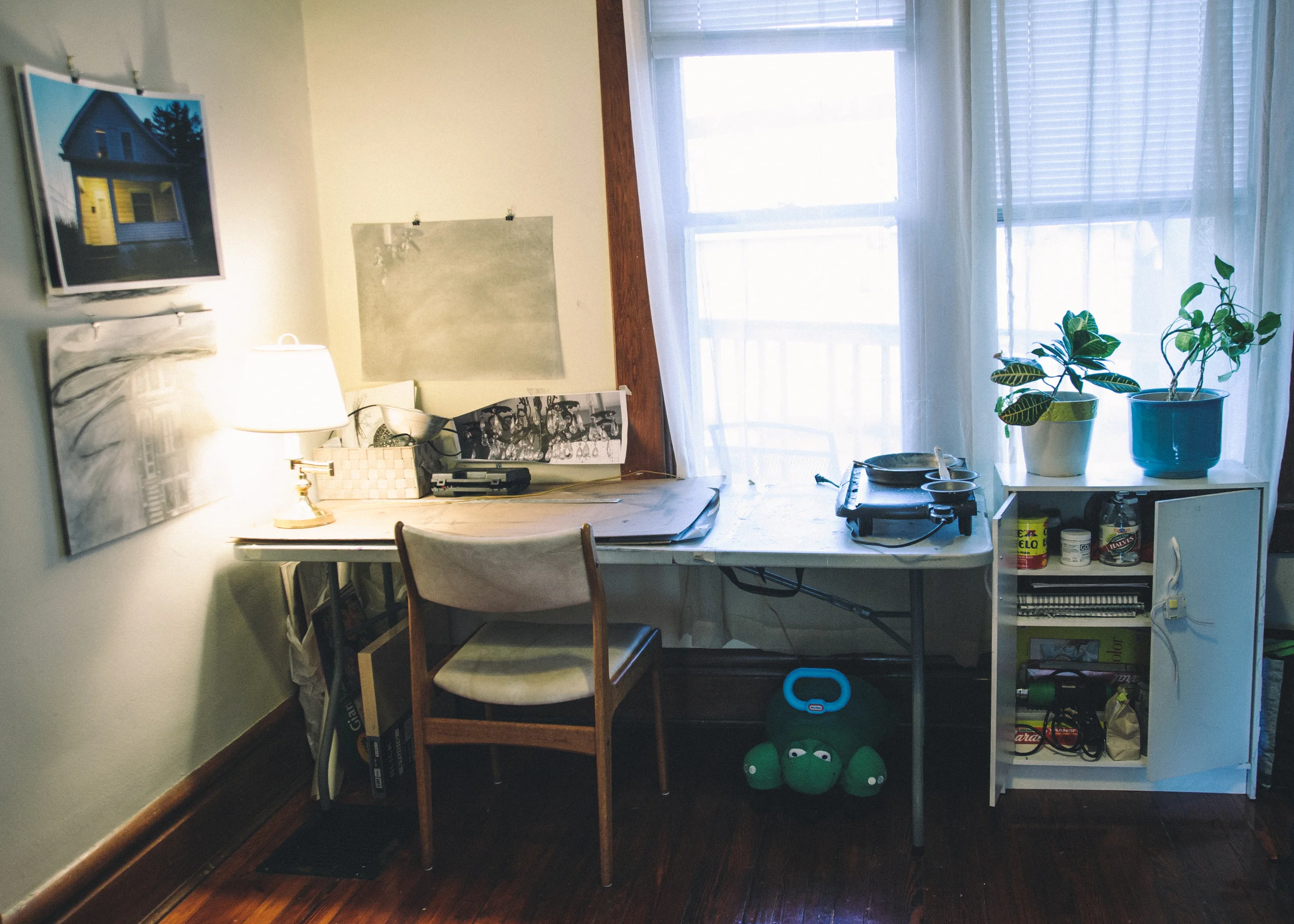 Laura's home studio overlooks the back yard where a series of bird feeders bring nonstop chirping and chatter of a variety of birds. She now shares the space with her daughter's toys.