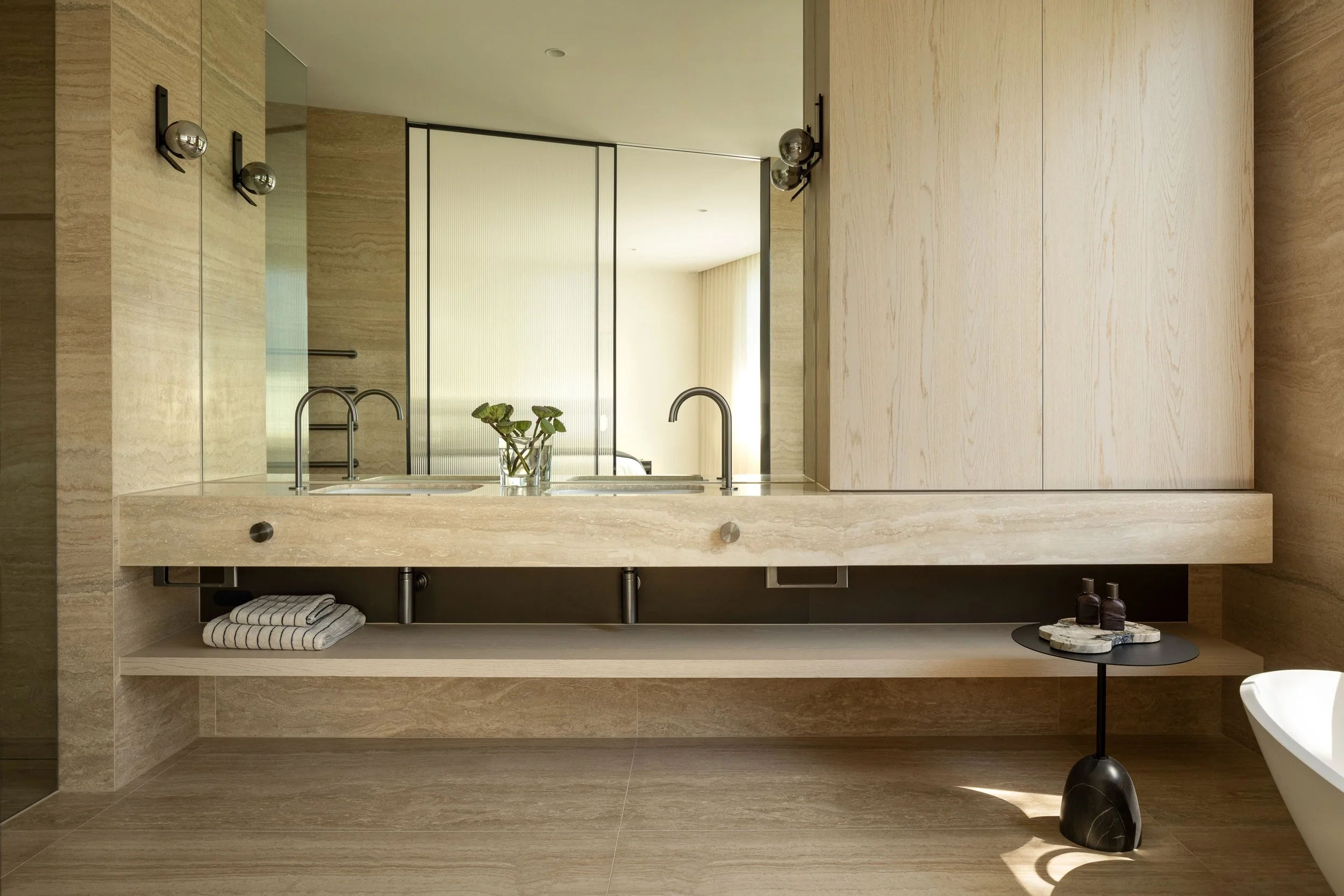 A look inside the master ensuite at our recently completed Toorak Project &mdash; where natural stone, soft textures, and refined detailing create a calm and quietly luxurious retreat.

Builder: @easton__co 
Developer: @panarea_one 
Architect: @dndst