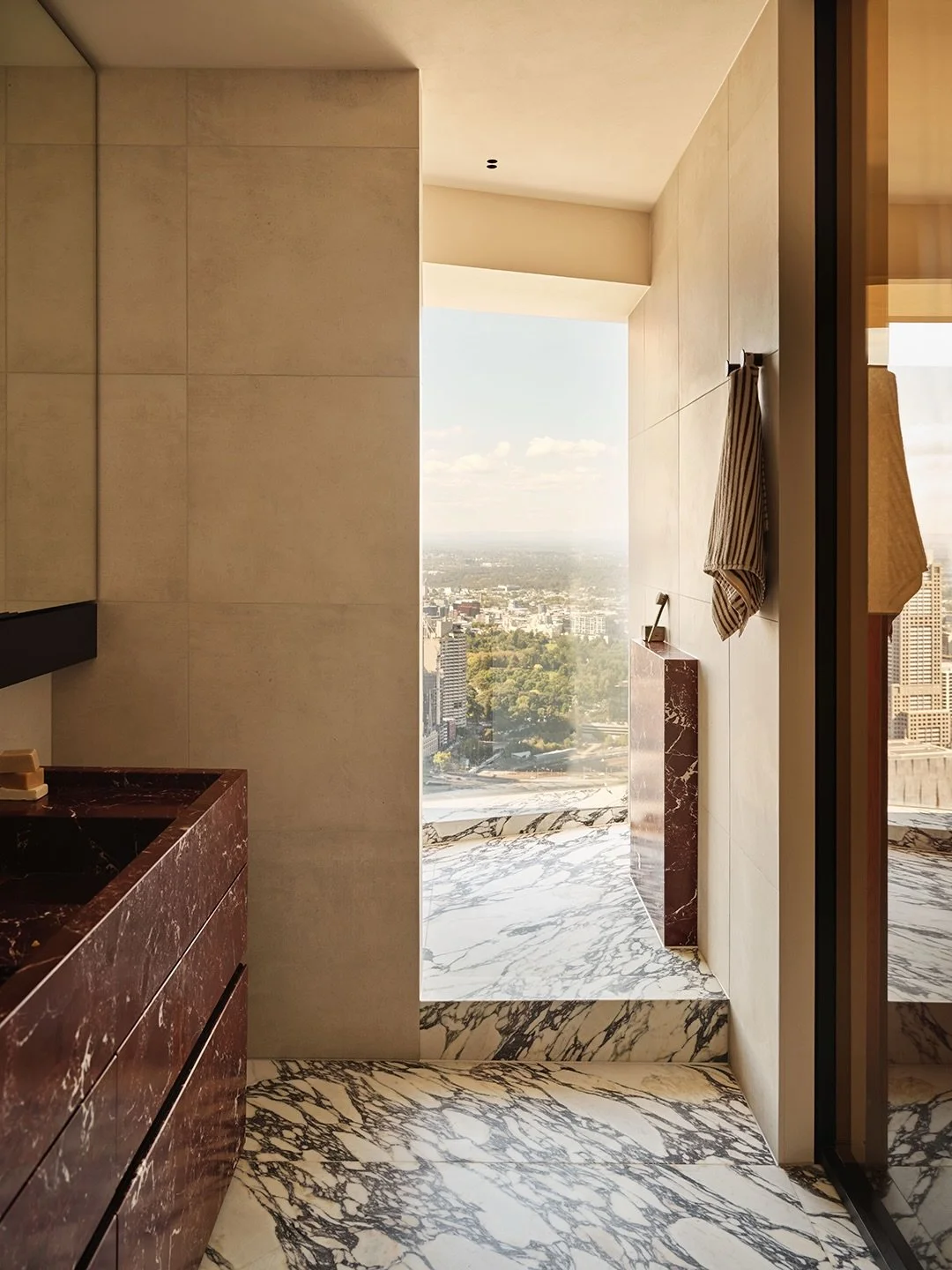 A shower with a view of the Melbourne CBD.

The main ensuite at our Eureka Residence features two of the most striking and luxurious natural stones to work with &mdash; Rosso Levanto and Calacatta Viola. Sourced from Italy, each slab was photo-matche