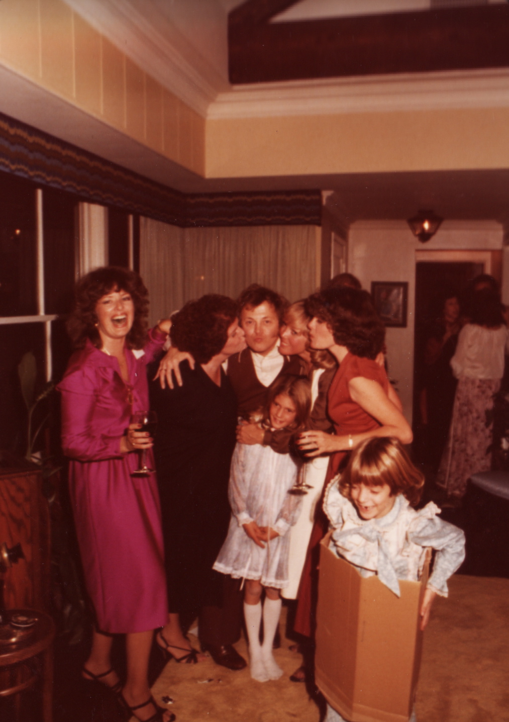 Dad's birthday party at our house (Dee kissing my dad's right cheek while I inexplicably run around in a box) - Nov. 1978