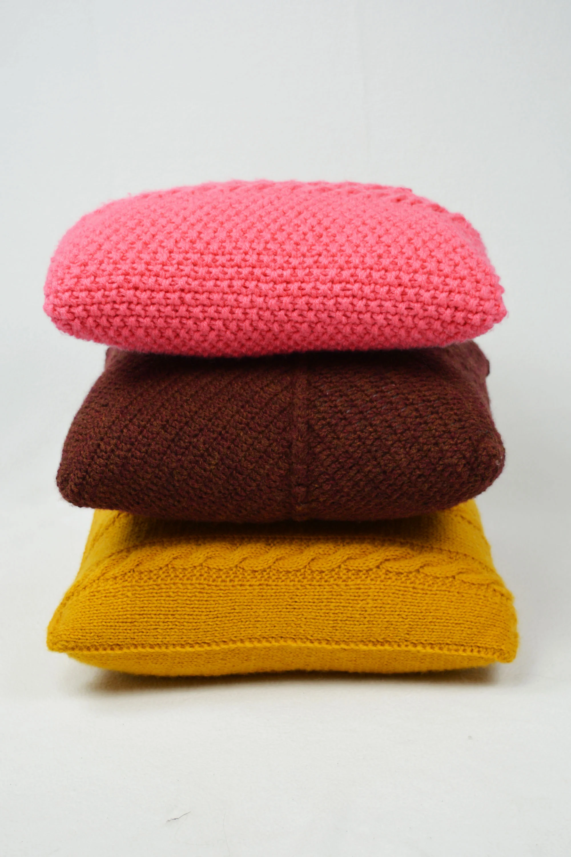 knit pillow stack maroon yellow and pink.jpg