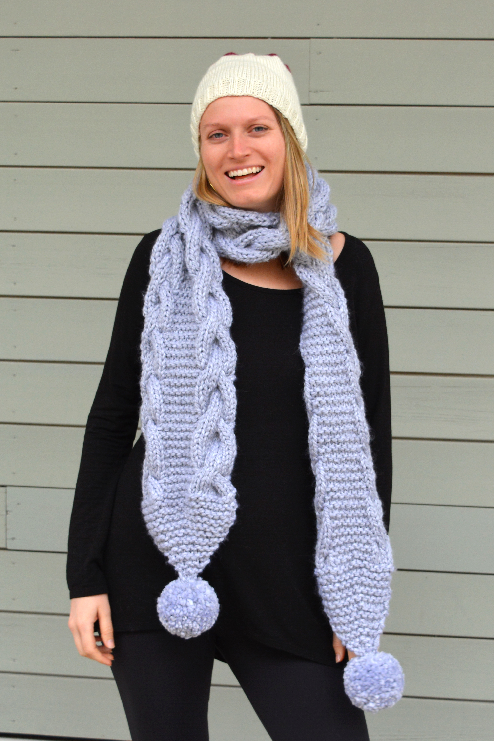 Knit periwinkle scarf with poms.jpg
