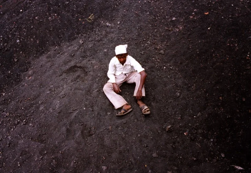 Boy on pile of coal. Shirwal, India (Copy)