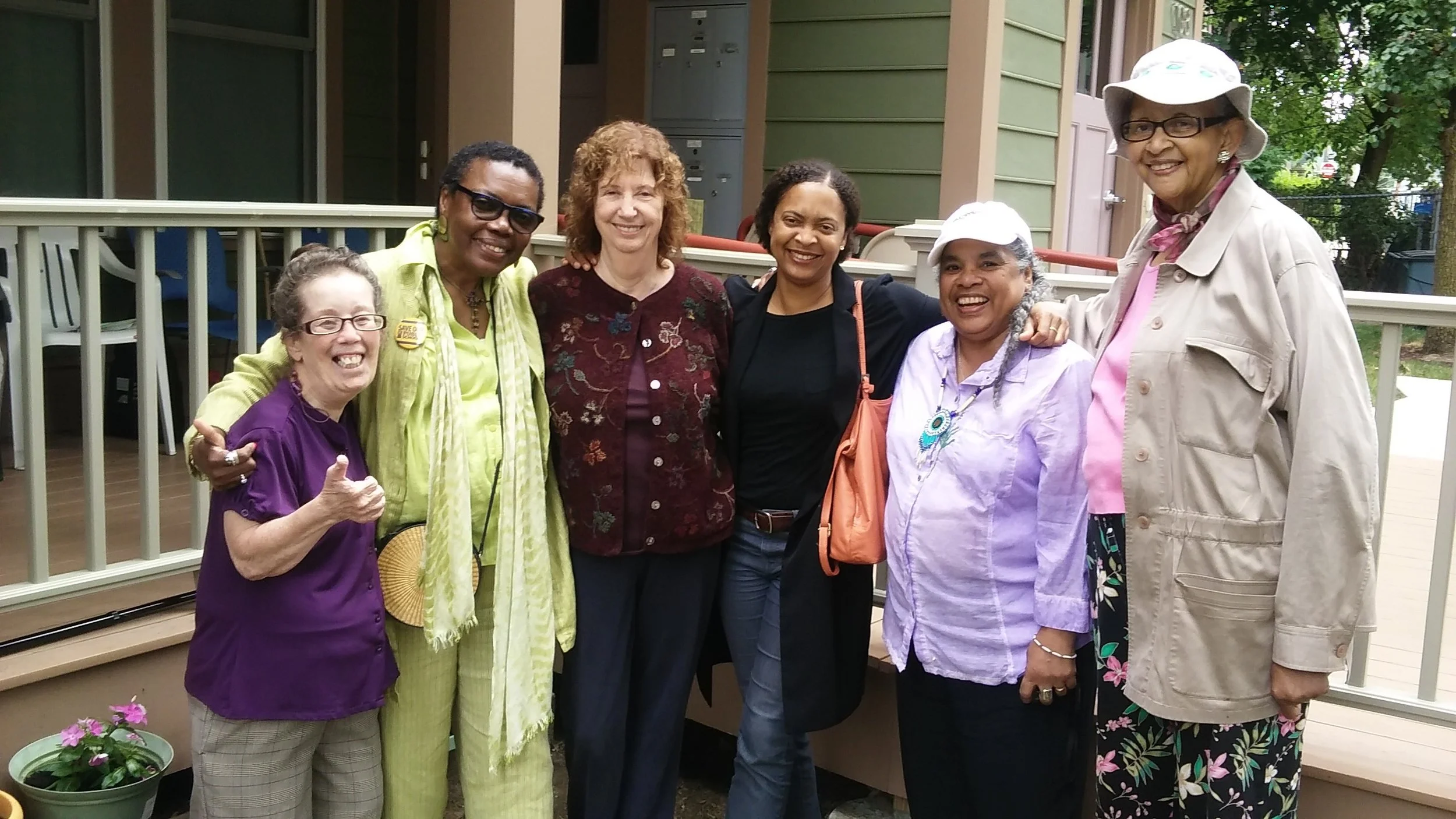 Courtesy Photo | Some workshop poets celebrate after their well-attended Jamaica Plain Porchfest performance in July, 2016. Left to right: poet Betsaida Gutierrez, whose porch was their “stage;” Gloria Johnson; workshop leader Sandra Storey; workshop founder and Poet Laureate of Boston Danielle Legros Georges; Cecelia Estrada Vaughan; and Gwen Lewis.