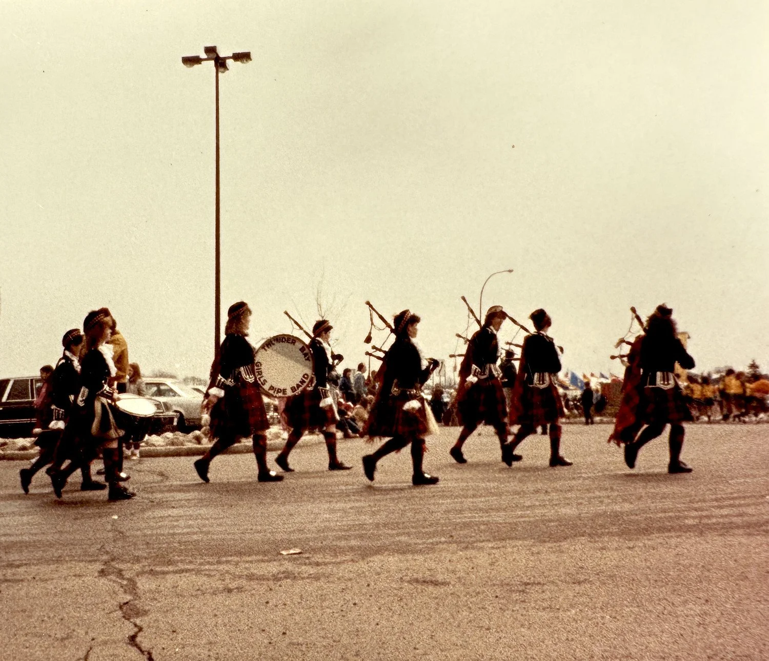 Thunder Bay Girls Pipe Band, marching in a parade, with an arrow pointing to Dana. Taken in the 80s.