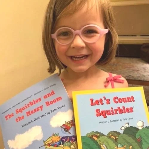 Little girl with glasses and two adorable children's books