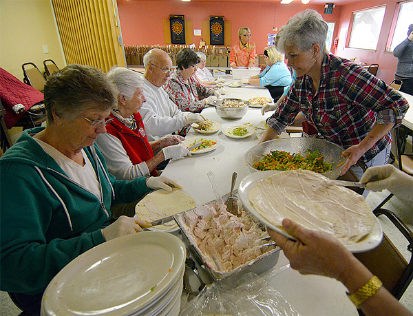 Readiness to Learn volunteers help prepare box lunches for a fundraiser last Wednesday morning. The organization sold 371 lunches in all, bring in revenue for student programs. — Image Credit: Justin Burnett / The Record