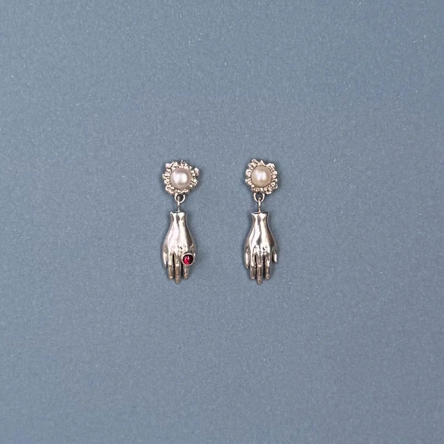 Decorate your lobes with these mischievous handy fellows resplendent with a raspberry rhodolite garnet and lustrous frosted pearls. 

The new collection is launching soon! Make sure you are subscribed to receive your exclusive friend&rsquo;s discount