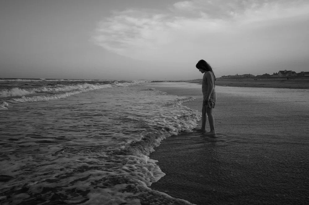  one of my favorites of emily at the beach at stone harbor. she loves the beach and we took a stroll after dinner and she stood there connected to the water :)! 
