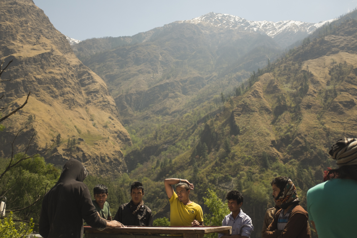 BENNI Newari locals play a game of Karem board, where small marble discs are flicked with the goal of knocking opponents pieces into one of the four corners. A thin layer of chalk covers the board to aid movement of the disks.
