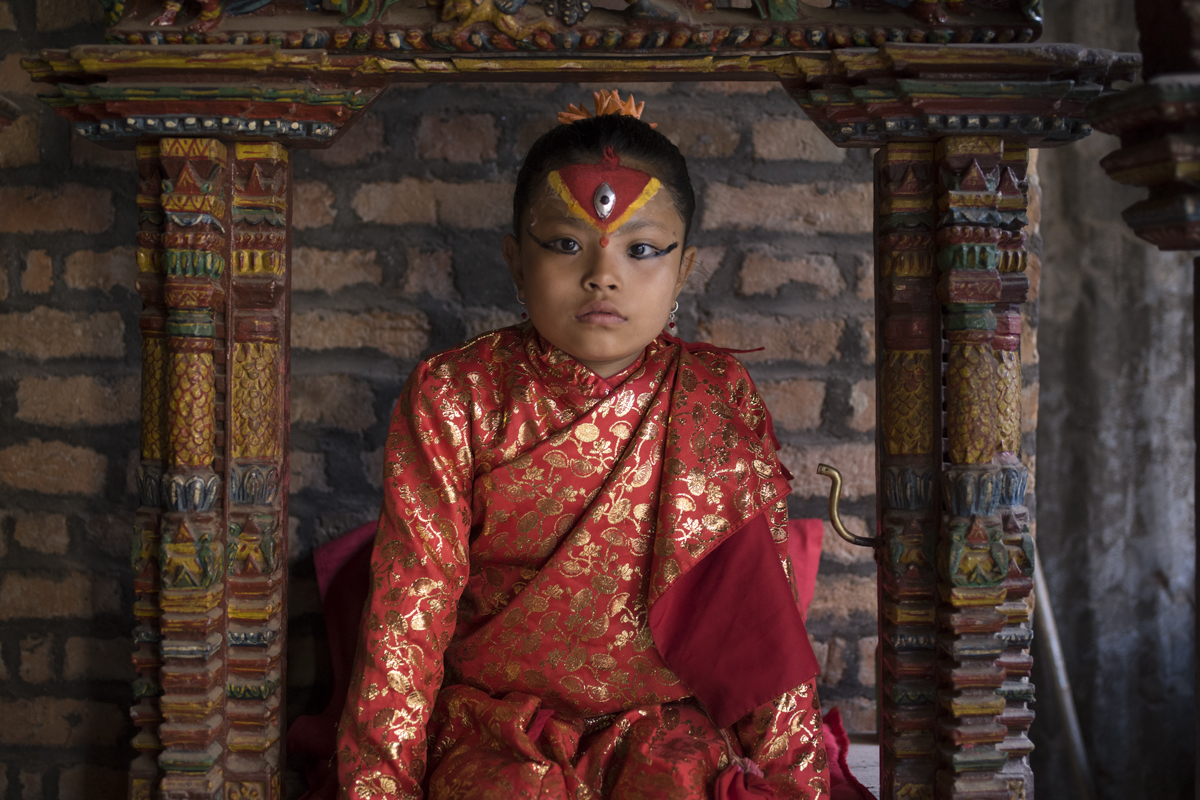 BHAKTAPUR Junisha Shakya, age 9, sits at her throne in her temple on the edge of Naga Pokhari in Bhaktapur.