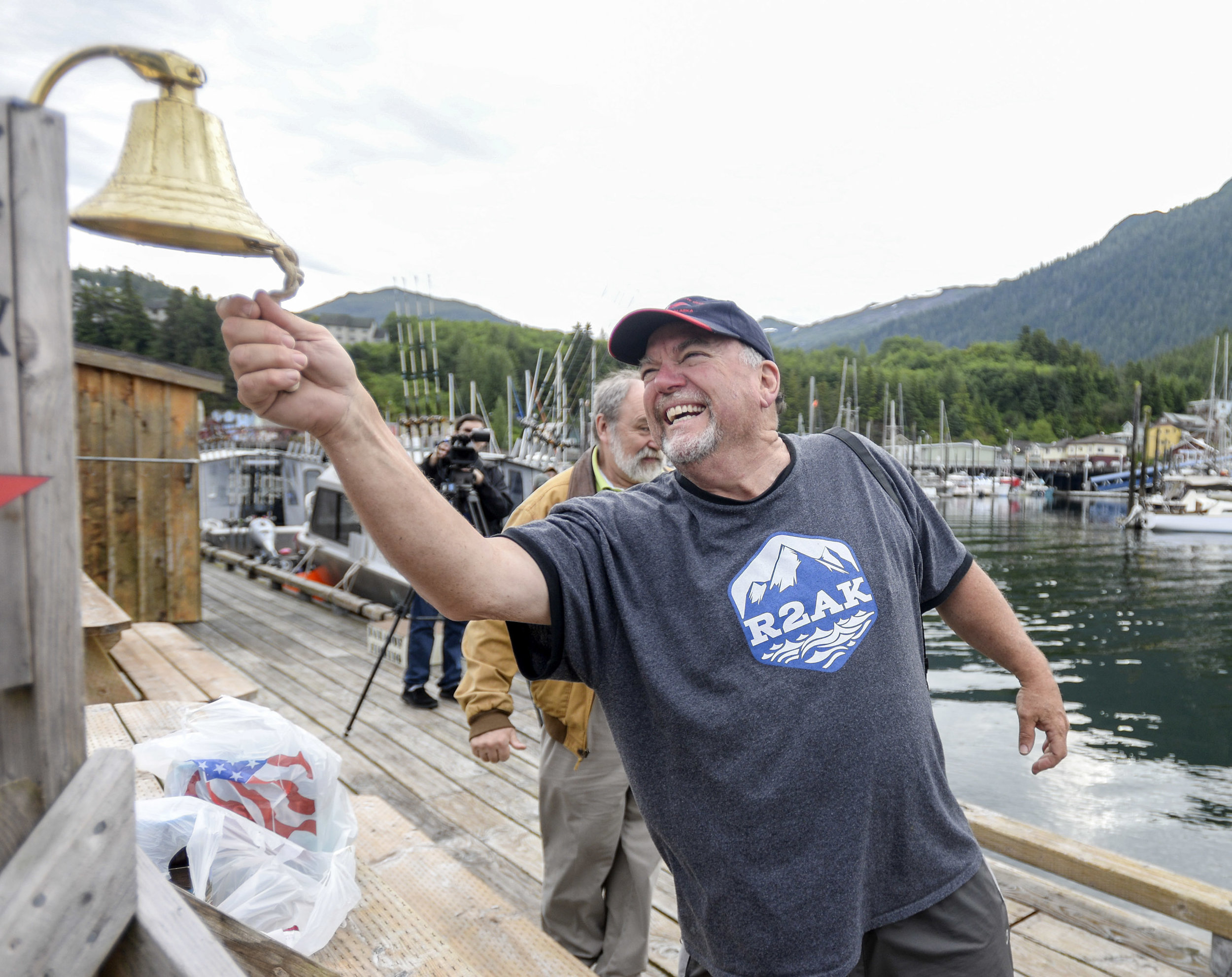  Team Ketchikan captain Charlie Starr laughs and smiles as he rings a ceremonial bell signifying his team's completion of the Race to Alaska on Thursday, July 7, 2016, at the Baranof Fishing docks in Thomas Basin. ©Ketchikan Daily News 