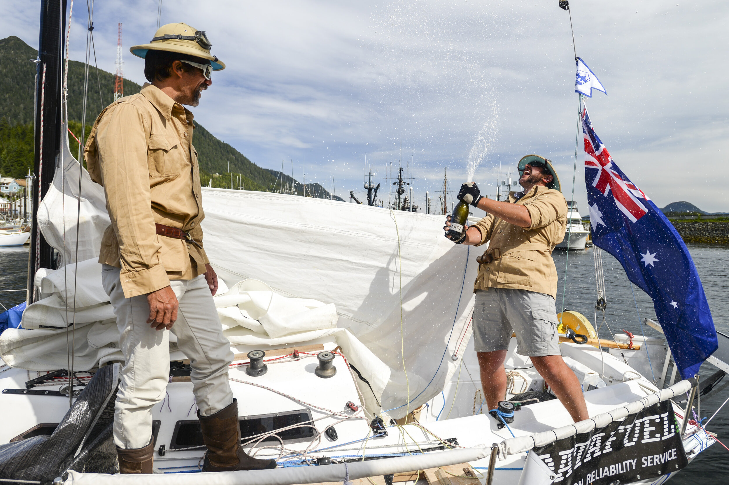  Michael Scholz watches as Frederic Chanut, right, pops a bottle of champagne Friday, June 23, 2017, as the pair finished the Race To Alaska. © Ketchikan Daily News 