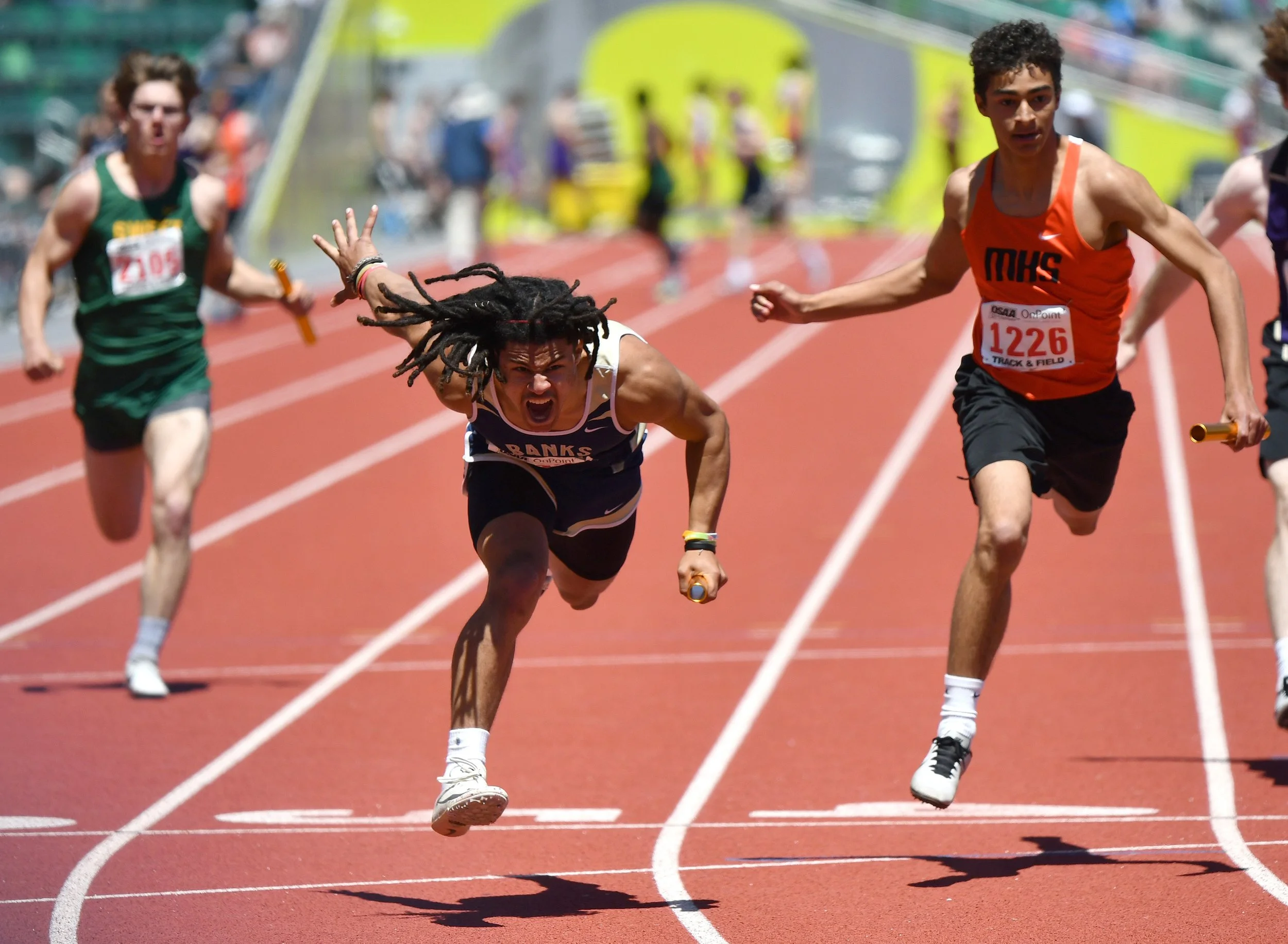   World Sports Photography Awards Finalist   Banks senior Jamar Flippen, center, lets out a yell May 21, 2022, after winning the 4A boys 4x100 relay event at the OSAA State Track and Field Championships at Hayward Field in Eugene, Ore. 