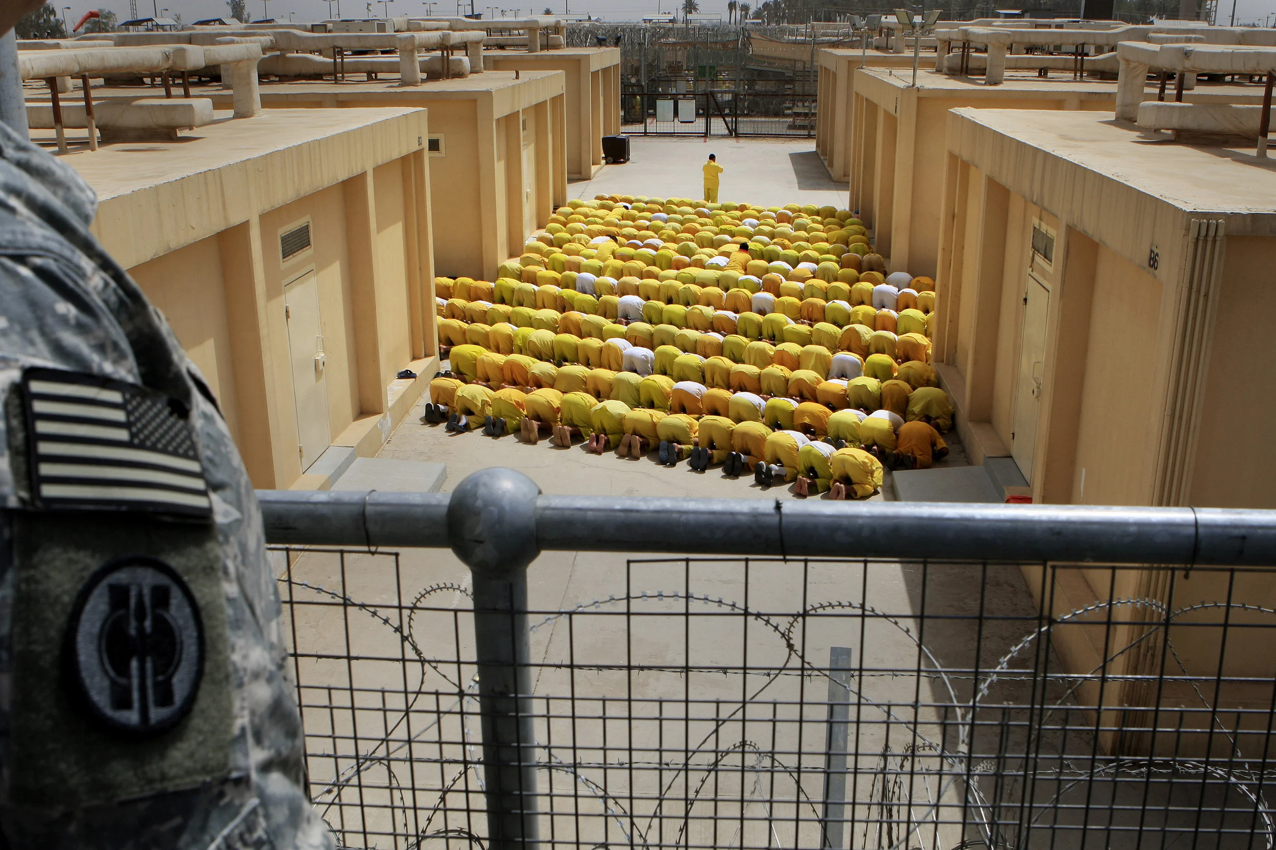 Iraqi detainees at the U.S. run prison, Camp Cropper, conduct mid-day prayers. Baghdad, April 2009.