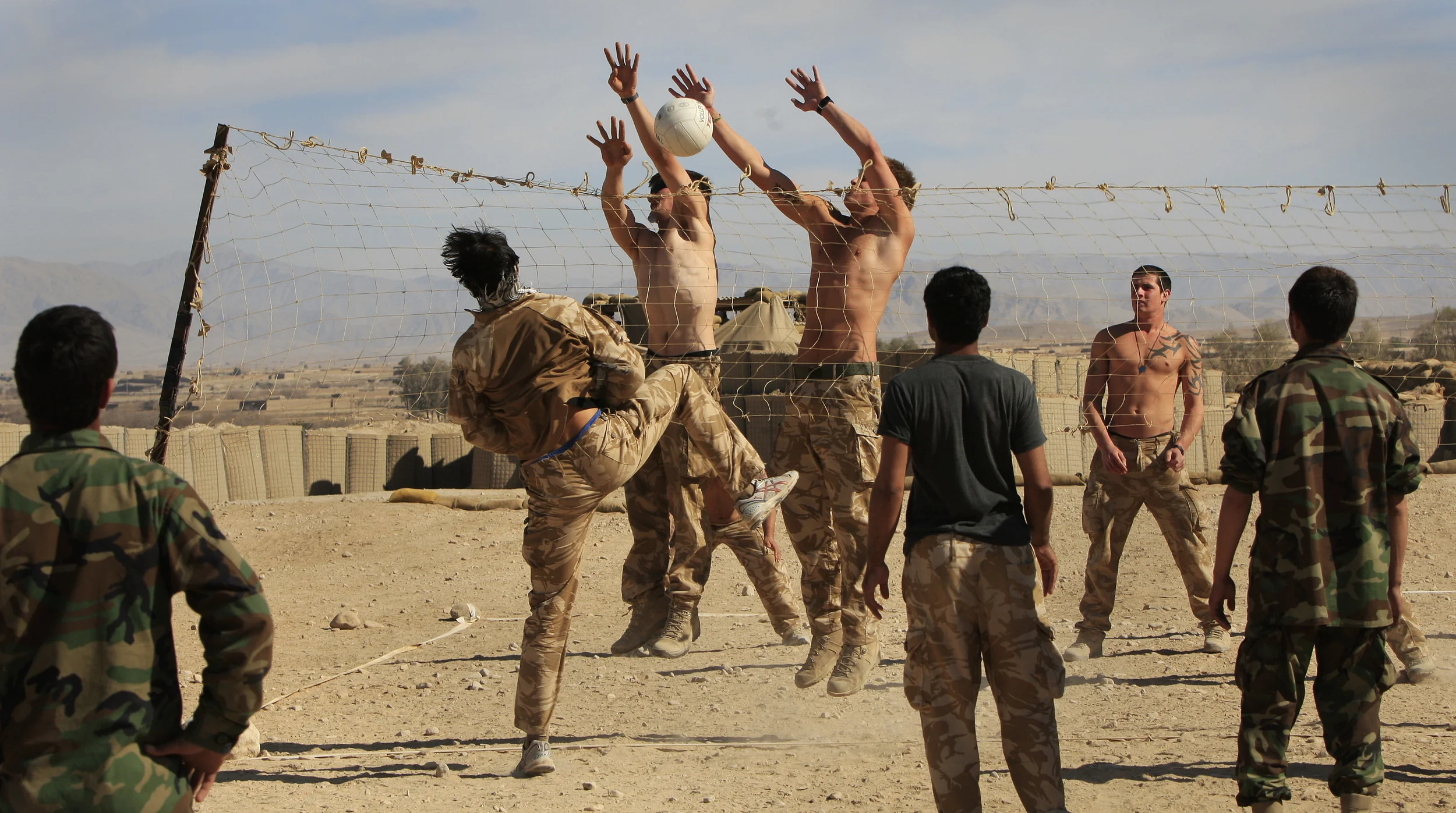  British soldiers of 3 Rifles play volley-ball with their Afghan interpreters at a base in Sangin, Afghanistan, 2010. 