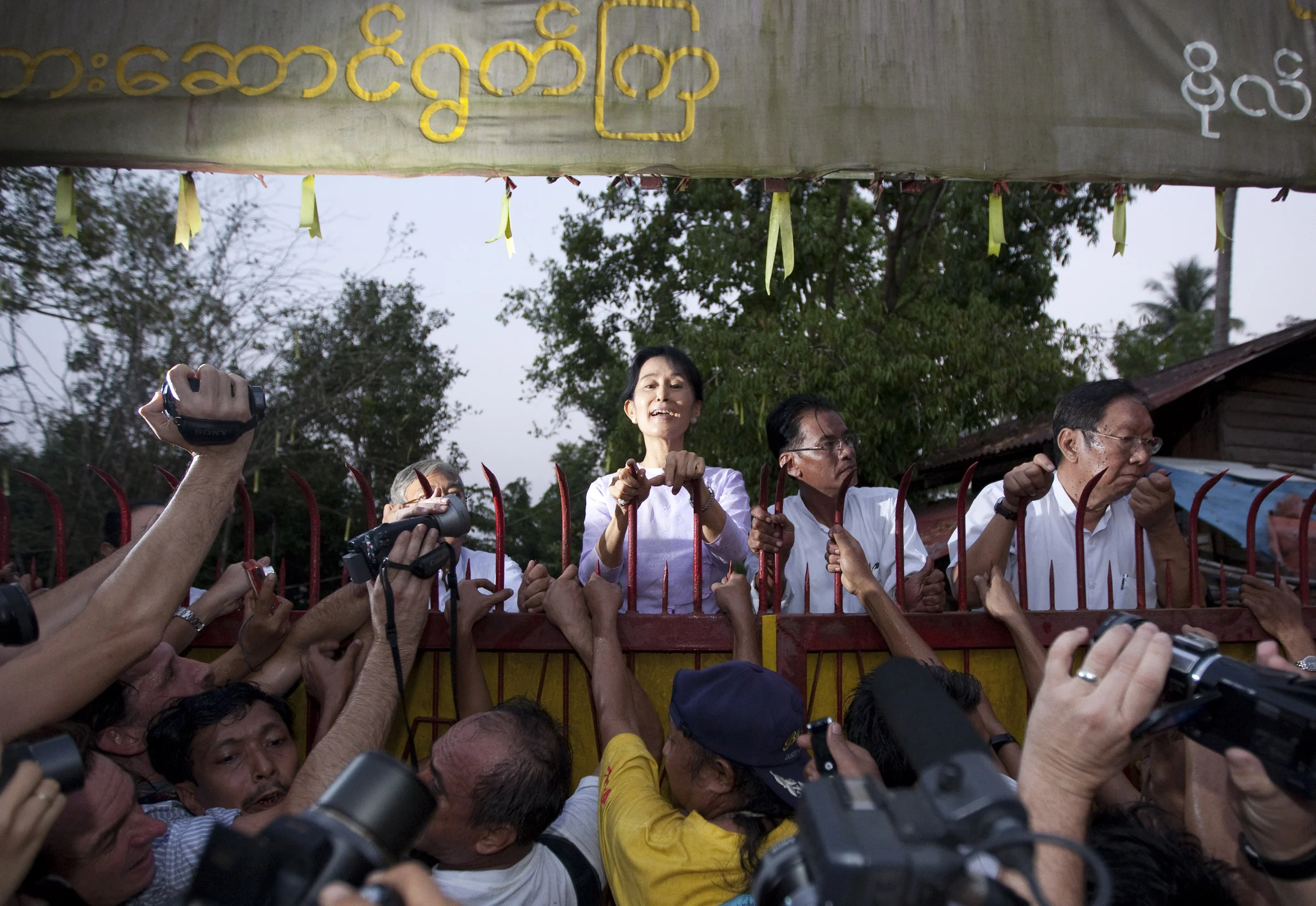  The first seconds of freedom for Burma's Aung San Suu Kyi as she appears at the gate of her house, to waiting crowds and where she was forced to remain for 15 years. Rangoon, 2010. 