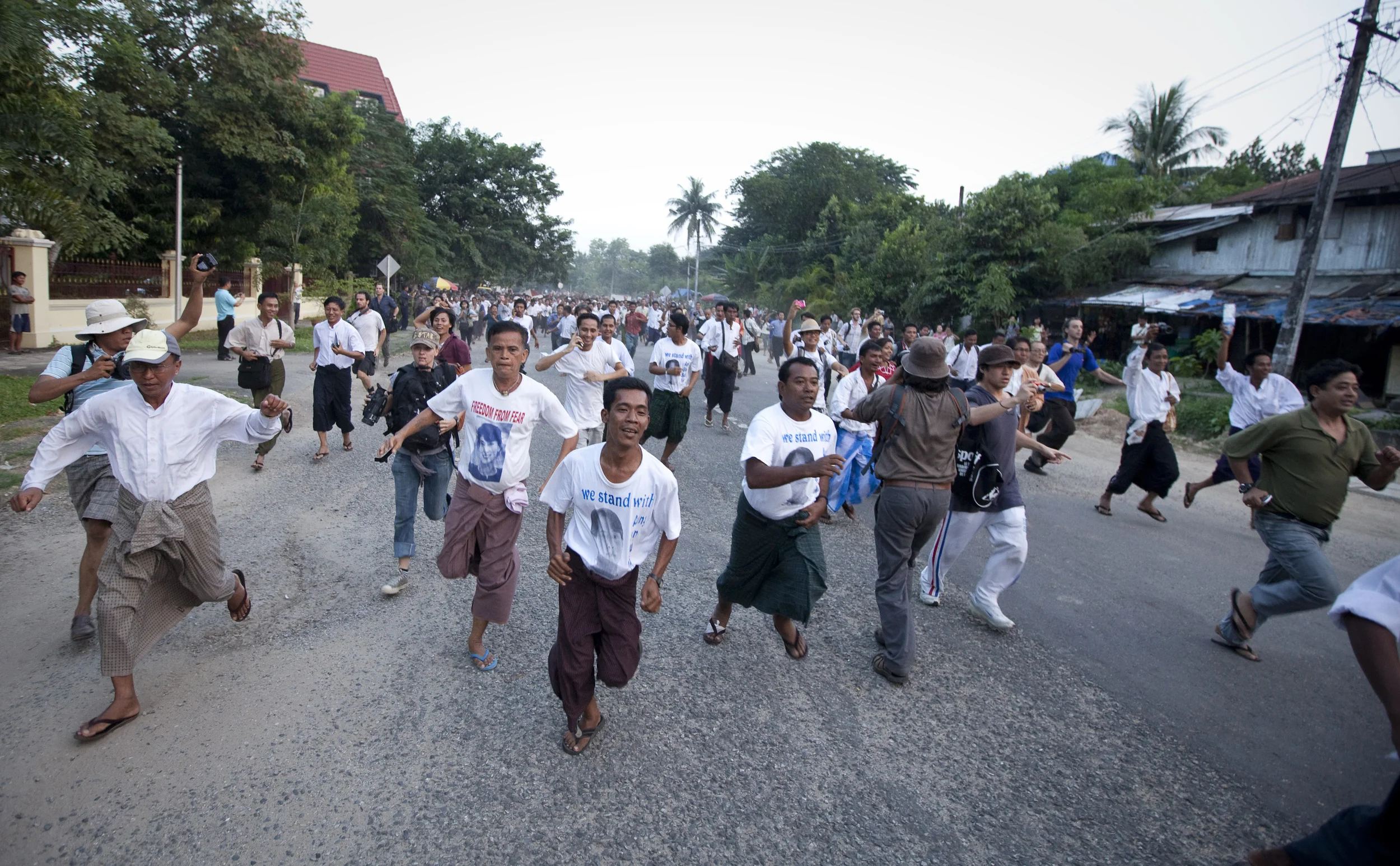 Supporters of Aung San Suu Kyi race towards her house the moment they hear of her freedom after 15 years of house arrest. Rangoon, 2010.