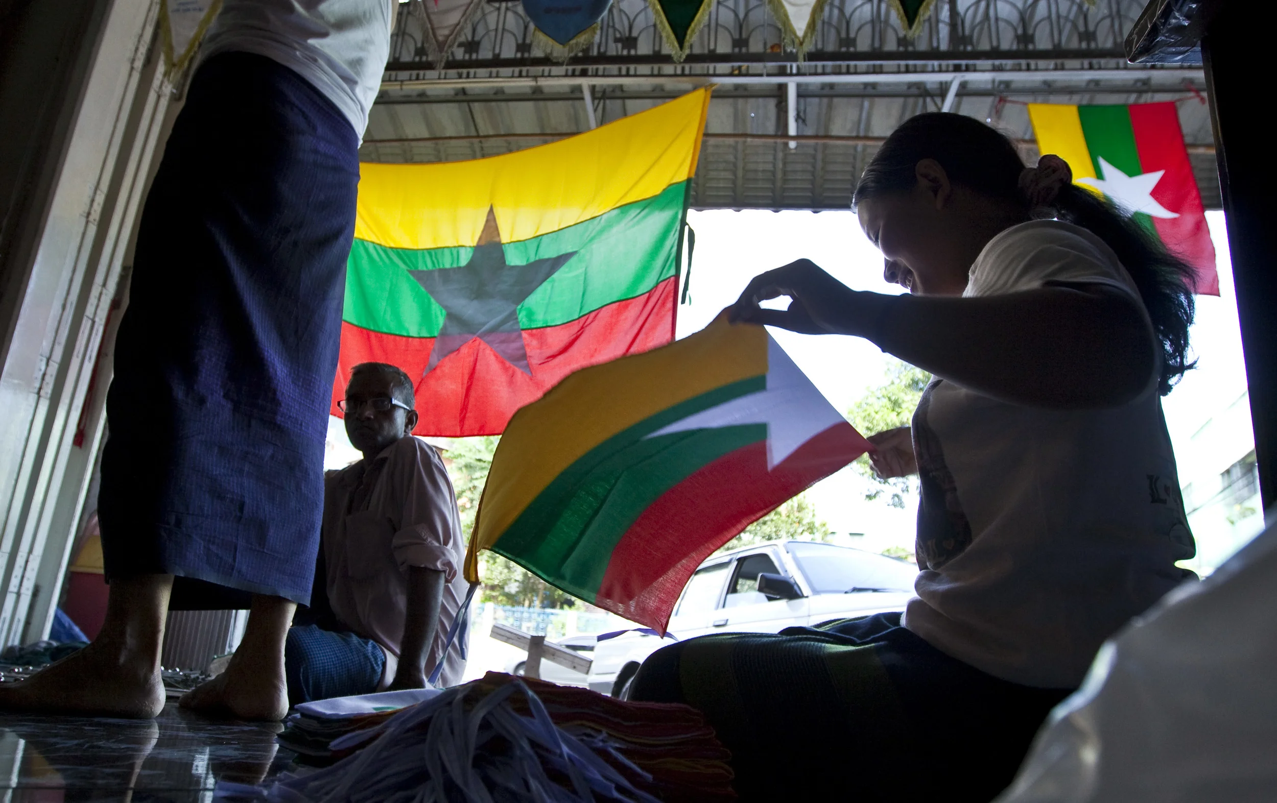  A small, roadside screen-printers shop producing the new flag of Burma, Rangoon, 2010. 