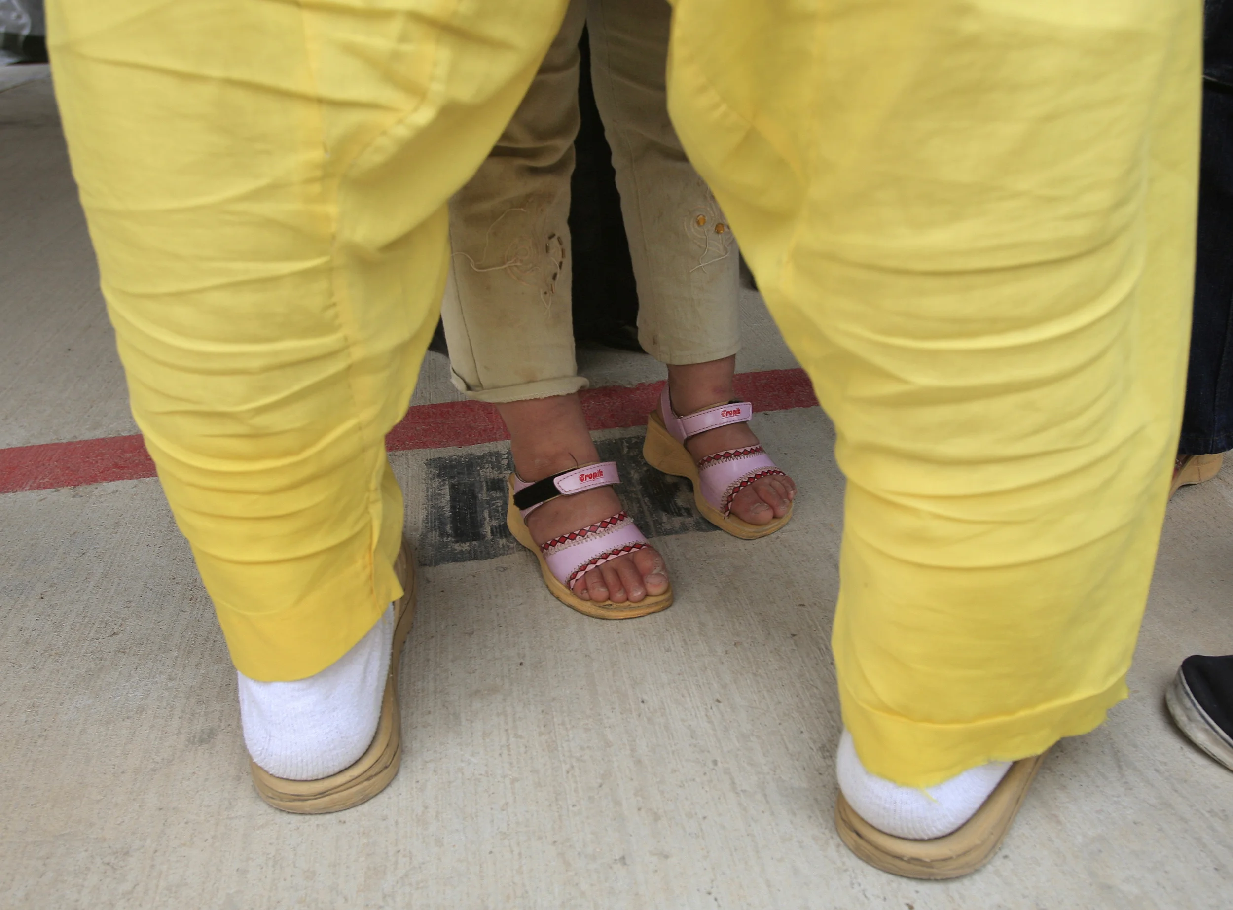 Iraqi detainees at the U.S. run prison, Camp Cropper, are allowed family visits and physical contact, although neither party's feet should cross a red line and are under constant watch by U.S. military guards. (Identities concealed as they are suspects only at this point, not convicts). Baghdad, April 2009.