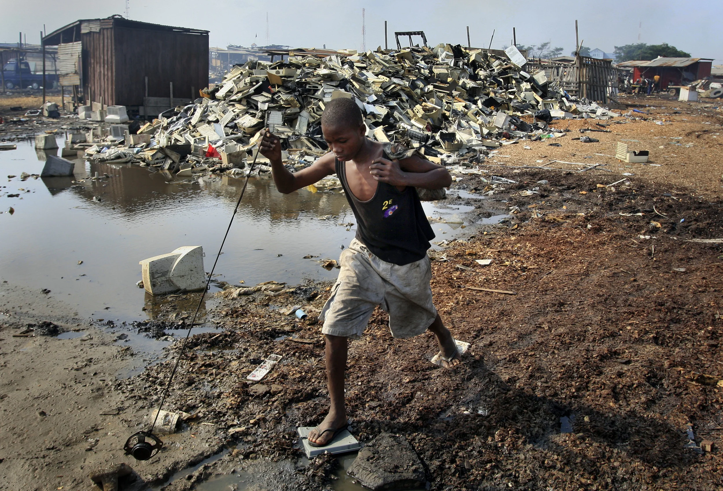 A young computer salvager at Agbogbloshie in Accra, Ghana, where the re-cycling of computers components happens with catastrophic environmental consequences. July 2009.