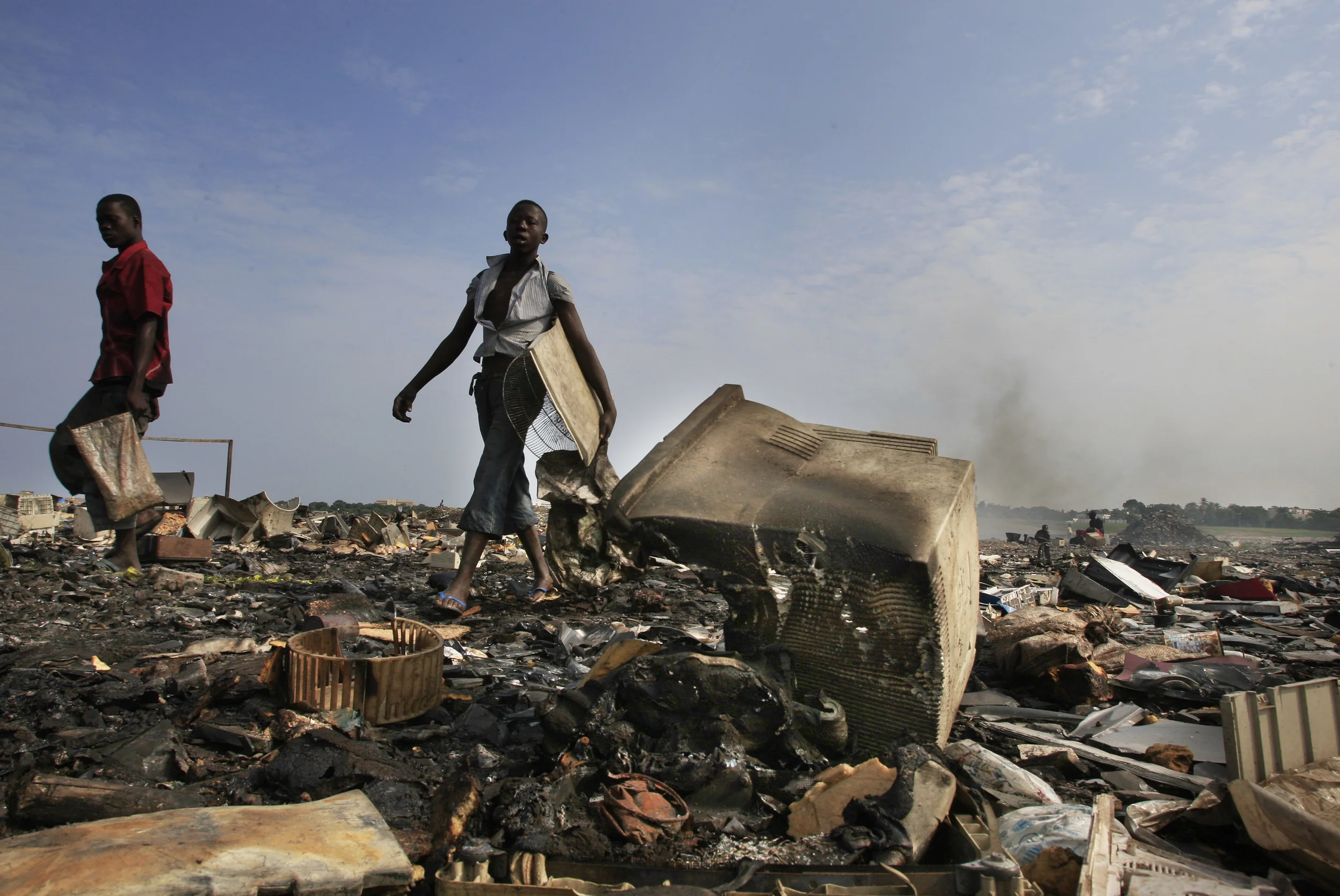 The charred remains of computer screen casings after their components of computers have been re-cycled, with catastrophic environmental consequences. Agbogbloshie, Ghana, July 2009.