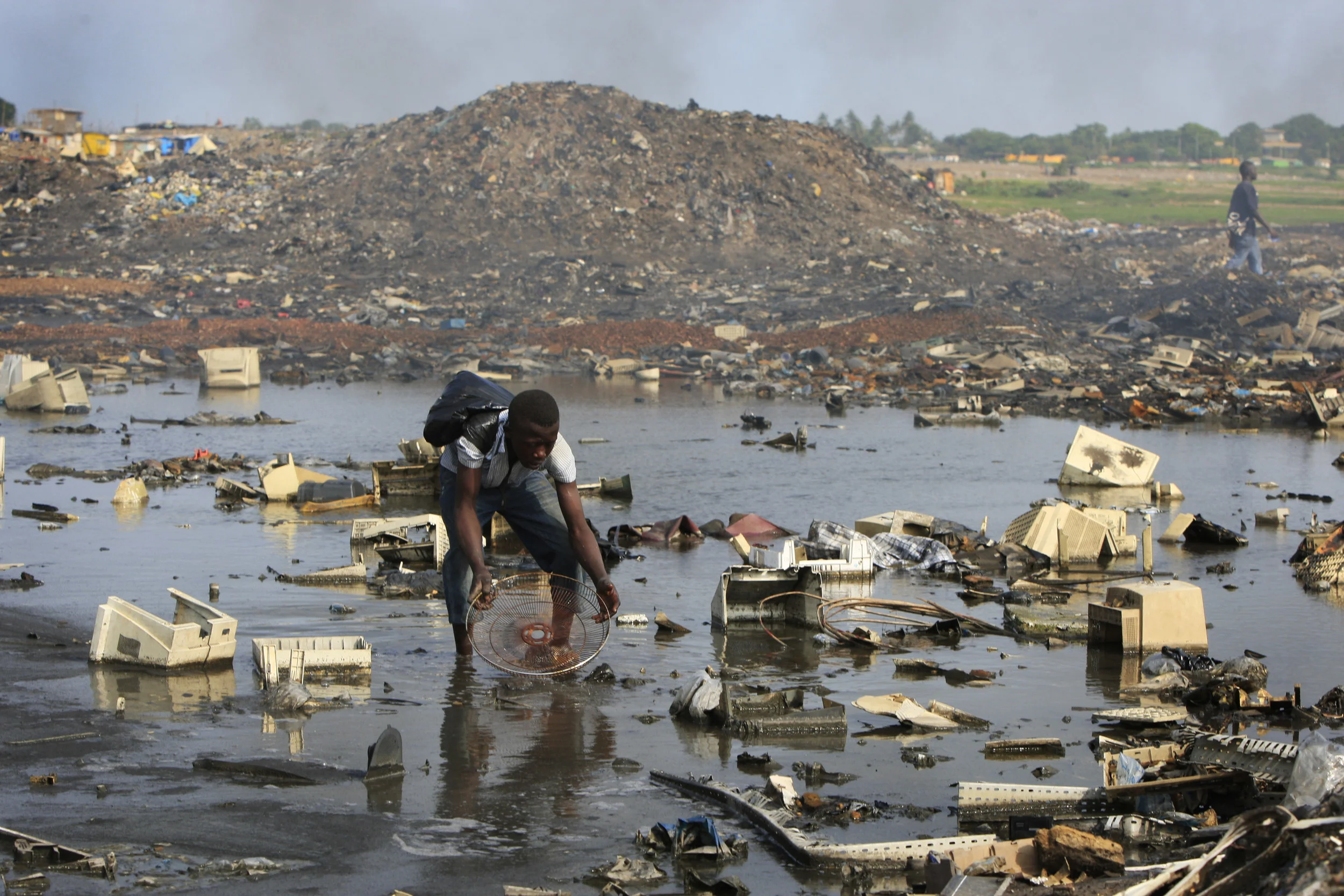 A computer salvager at Agbogbloshie in Accra, Ghana, where the re-cycling of computers components happens with catastrophic environmental consequences. July 2009.